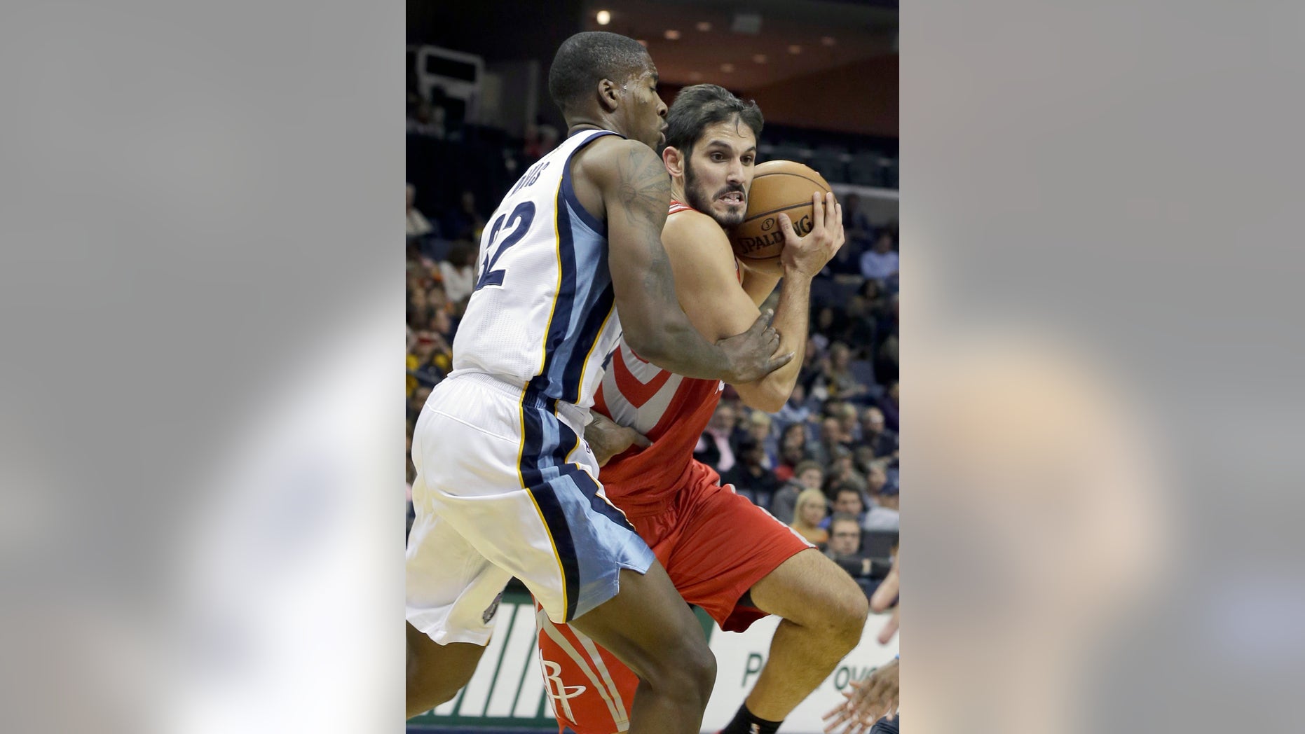 Memphis Grizzlies' Ed Davis (32) defends against Houston Rockets' Omri Casspi, right, of Israel, during the first half of an NBA preseason basketball game in Memphis, Tenn., Friday, Oct. 25, 2013. Casspi scored 11 points in Houston's 92-73 victory over Memphis. (AP Photo/Danny Johnston)
