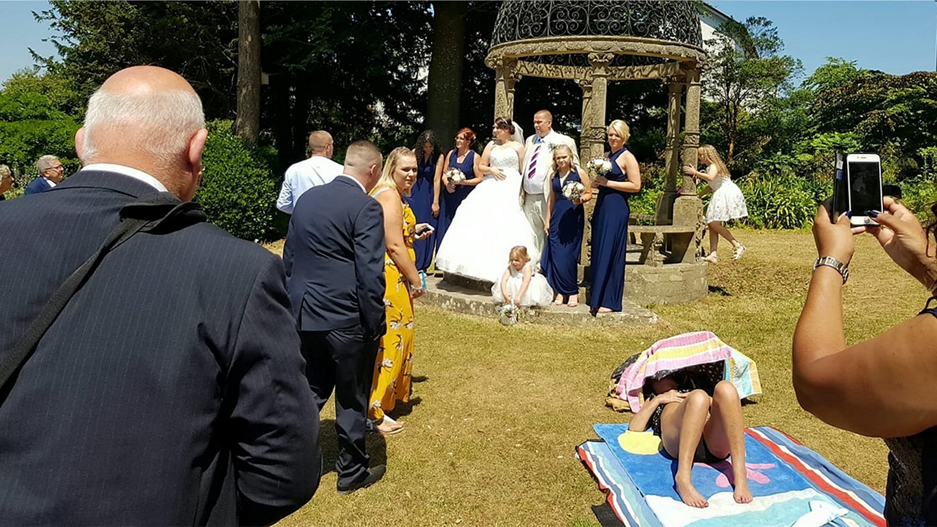 A sunbathing woman allegedly refused to move out a couple's wedding photos.