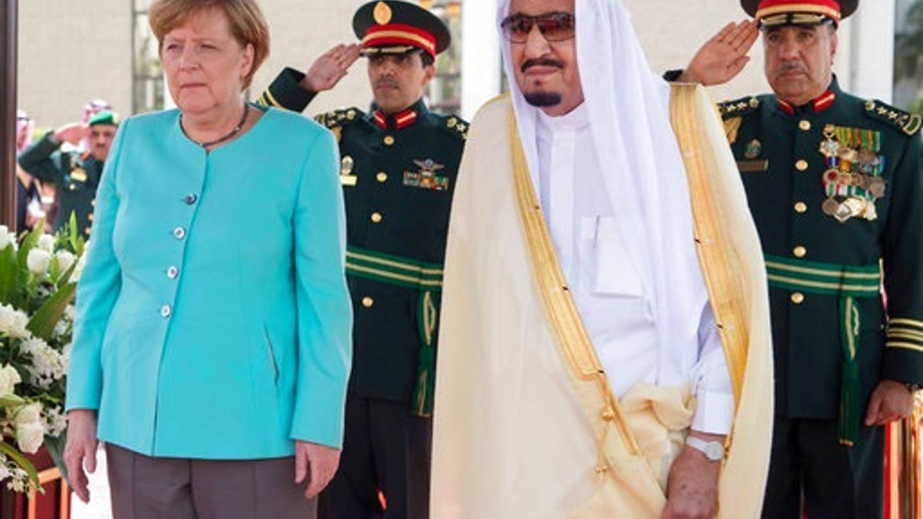 In this photo released by the Saudi Press Agency, SPA, German Chancellor Angela Merkel, left, is received by Saudi King Salman on her arrival to Jiddah, Saudi Arabia, Sunday, April 30, 2017. Merkel arrived Sunday for talks with the oil-rich kingdom's monarch, beginning a two-nation trip to the Gulf. (Saudi Press Agency via AP)