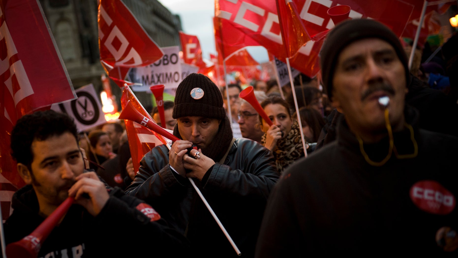 People blow whistles and horns during a demonstration against job cuts at bailed-out bank Bankia in Madrid Wednesday Jan. 23, 2013. Spain's recession deepened in the fourth quarter of 2012, when the economy shrank by 0.6 percent compared with the previous three-month period, according to preliminary estimates from the Bank of Spain on Wednesday.(AP Photo/Daniel Ochoa de Olza)