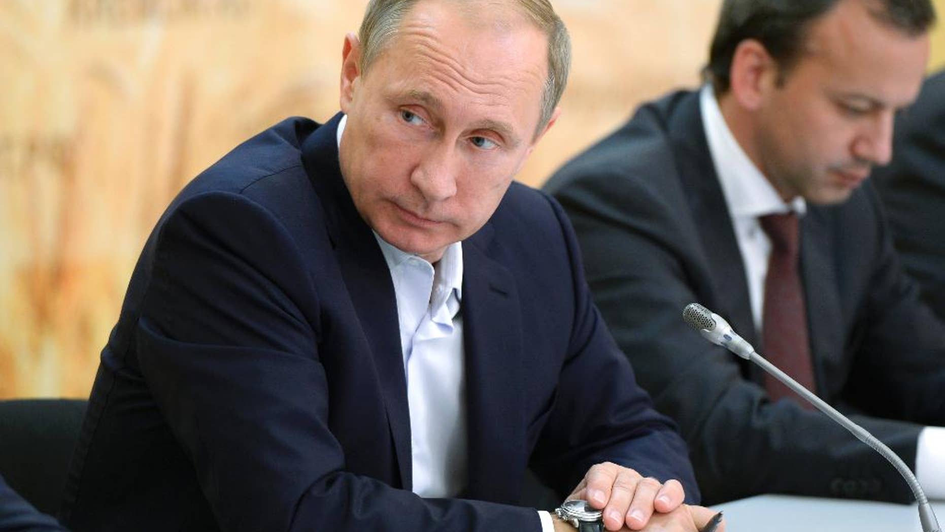 Russian President Vladimir Putin attends a meeting on agriculture while visiting farms in Rostov region, Russia, Thursday, Sept. 24, 2015. At right is Deputy Prime Minister Arkady Dvorkovich. (Alexei Nikolsky/RIA-Novosti, Kremlin Pool Photo via AP)