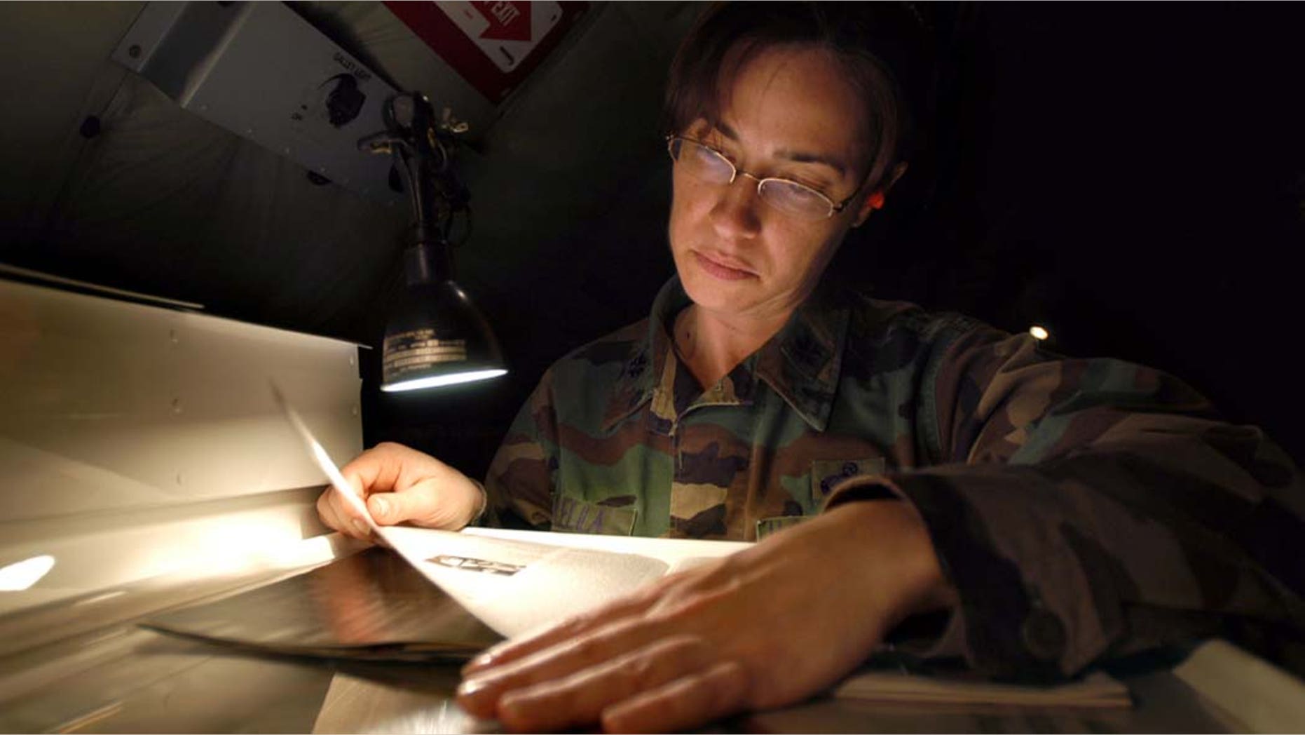 INCIRLIK AIR BASE, TURKEY--Lt. Col. Christina Vilella, 434th Aircraft Maintenance Squadron job title, catches up on some reading while trying to pass the time during an eleven-hour flight to Incirlik Air Base, Turkey. Colonel Vilella will assume the role of maintenance officer for the 385 Air Expeditionary Squadron during her deployment. (Air Force Photo/Senior Airman Mark Orders-Woempner)