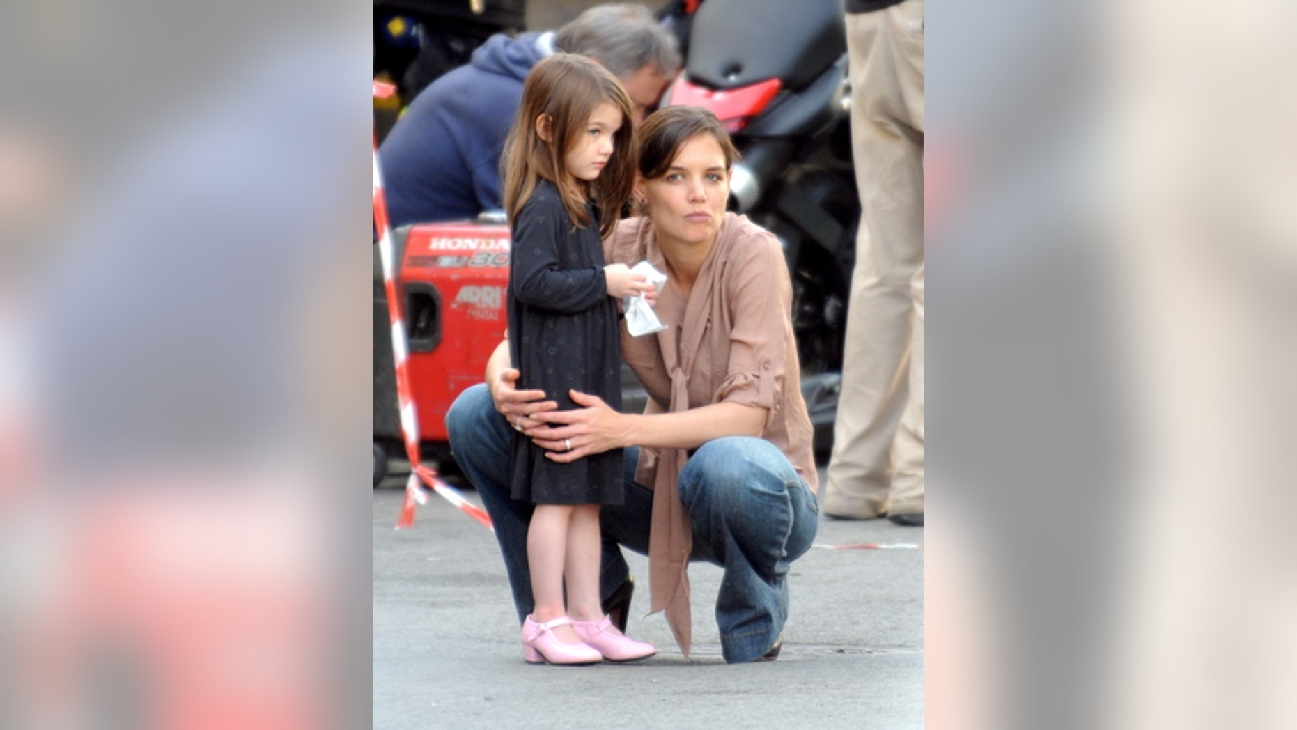 Katie Holmes and Suri Cruise watching Tom Cruise and Cameron Diaz on the set of "Knight and Day" in December 2009.