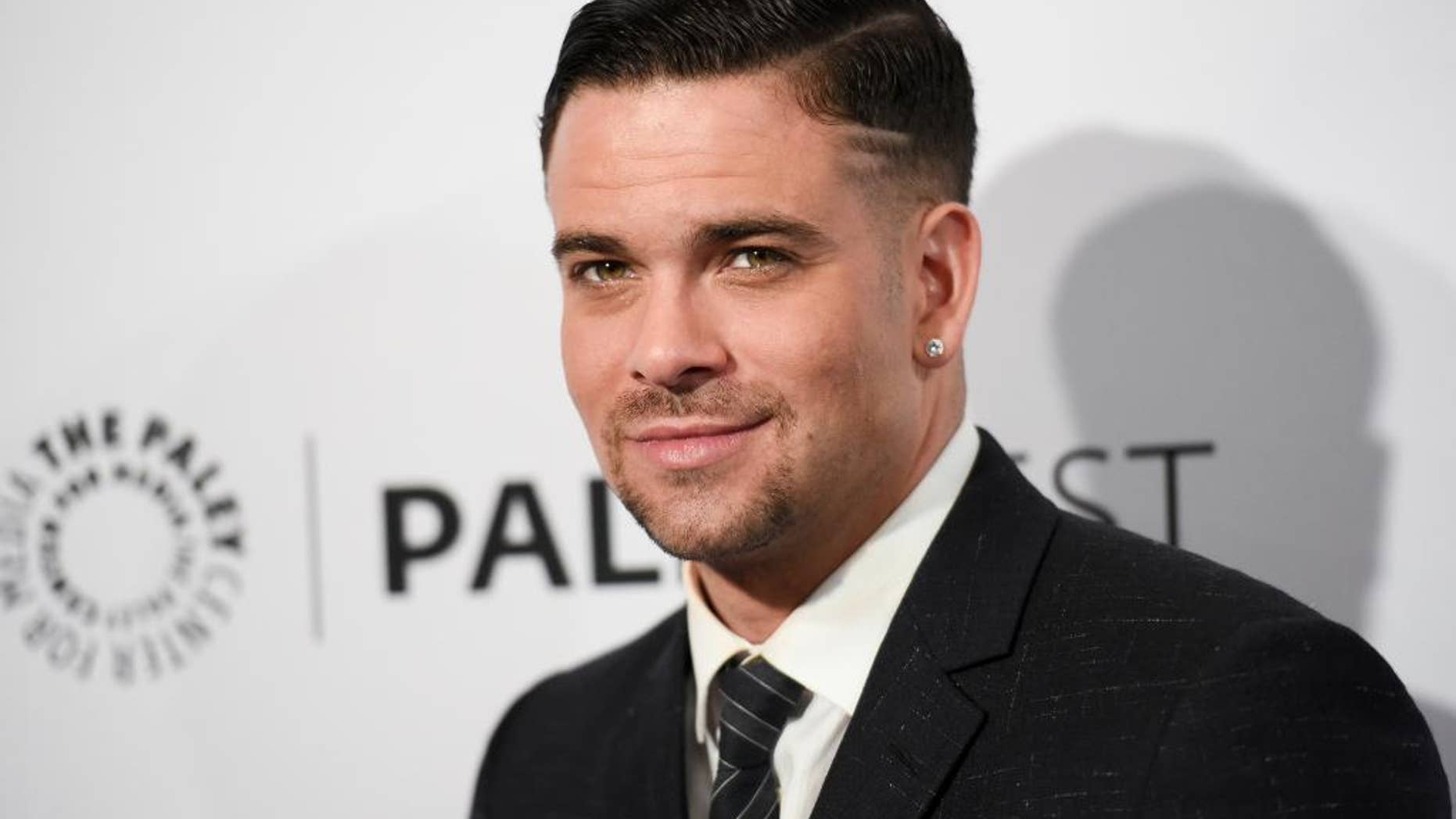 FILE - In this March 13, 2015 file photo, Mark Salling arrives at the 32nd Annual Paleyfest "Glee" held at The Dolby Theatre in Los Angeles. Salling, an actor who starred on the musical dramedy “Glee” is scheduled to turn himself in to federal authorities Friday, June 3, 2016, in a child pornography case. Salling, who played bad-boy Noah "Puck" Puckerman on the series, is scheduled to be arraigned on two charges of receiving and possessing child pornography. (Photo by Richard Shotwell/Invision/AP, File)