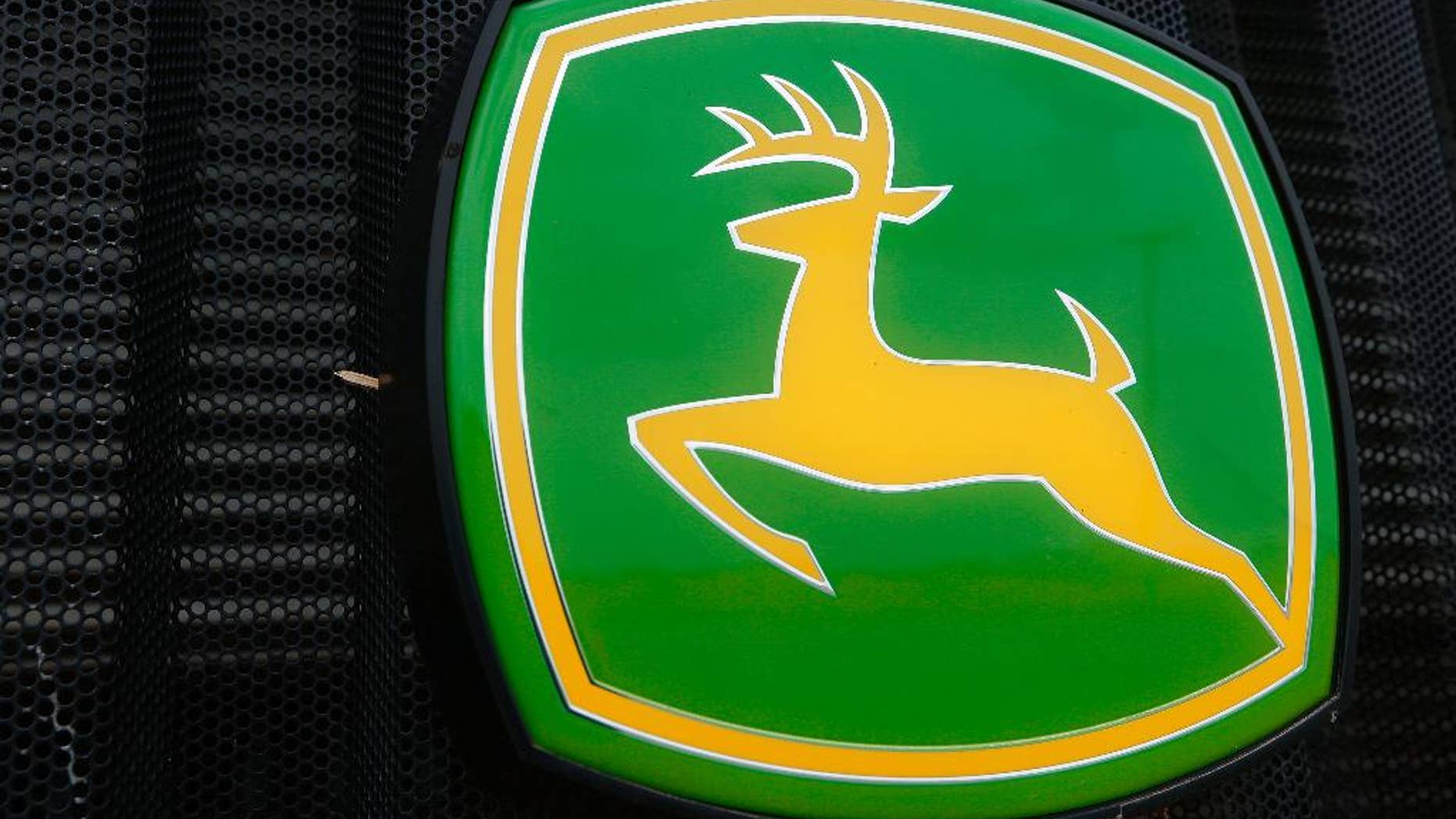 FILE - This June 8, 2014 file photo shows the John Deere farming logo at a farming equipment dealership in Petersburg, Ill. Even though sales of its green tractors, dozers and other equipment fell sharply, Deere & Co. reported better-than-expected fourth-quarter earnings as it cut costs. Also Wednesday, Nov. 25, 2015, the Moline, Illinois-based company posted an earnings outlook for the year that surpassed Wall Street expectations and its shares rose in premarket trading. (AP Photo/Seth Perlman, File)