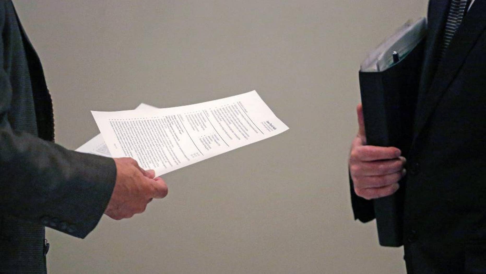 In this April 22, 2015 photo, a corporate recruiter, left, and a job applicant, right, speak during a National Career Fairs job fair in Chicago. The U.S. Labor Department reports on the number of people who applied for unemployment benefits during the week ending April 25 on Thursday, April 30, 2015. (AP Photo/M. Spencer Green)