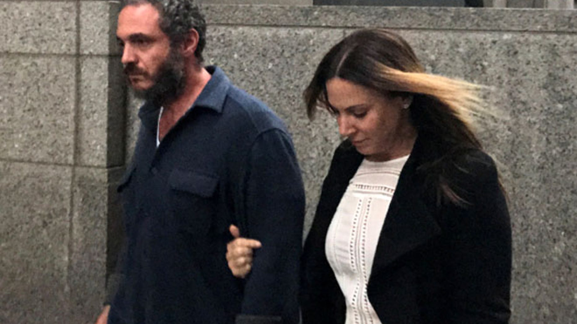 Joseph Meli and his wife exit U.S. Federal Court in Manhattan.