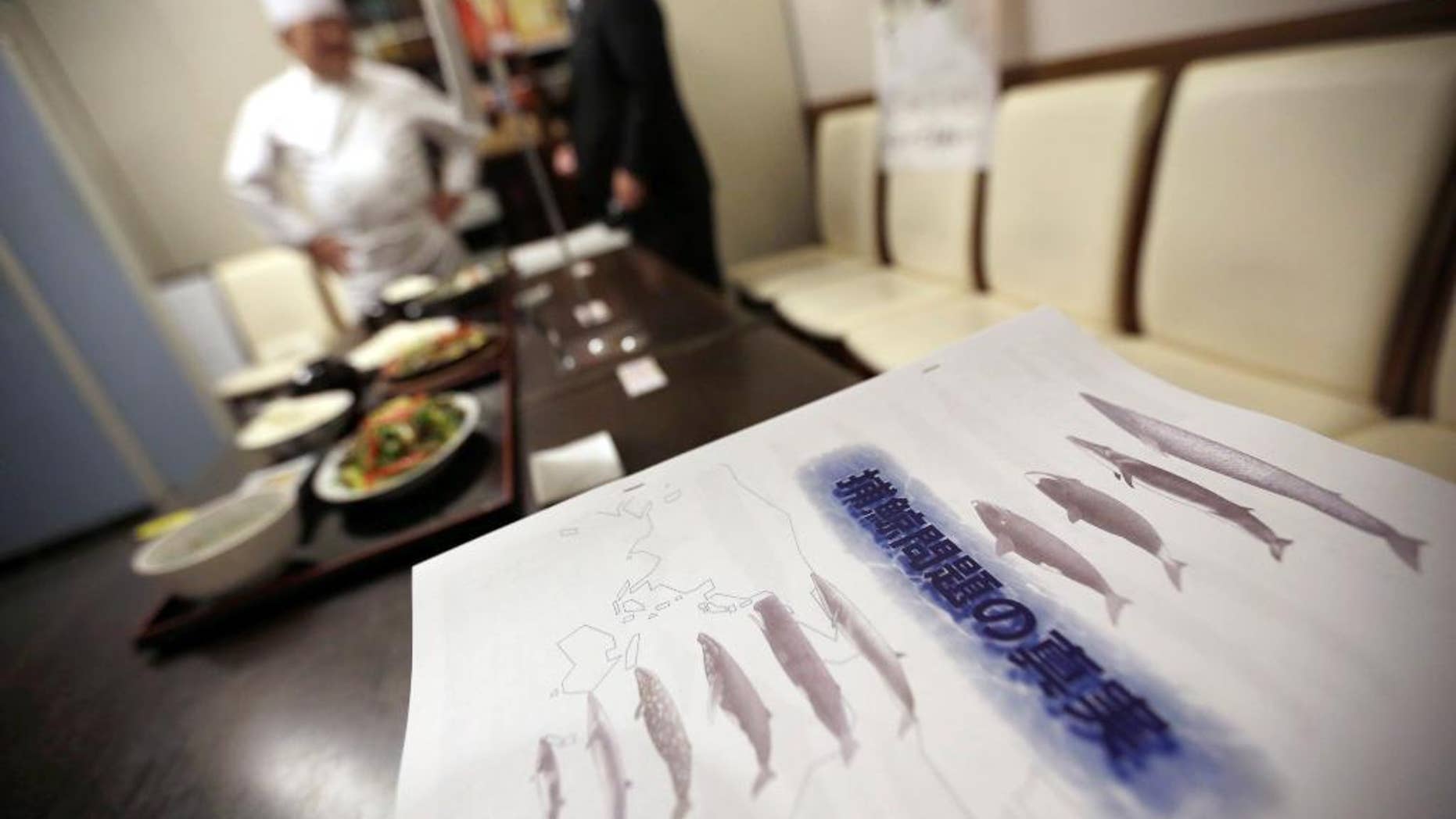 FILE - In this Nov. 19, 2014 file photo, booklets titled "The Truth of Whaling Problem" are placed next to whale meat dishes on display at a cafeteria of Ministry of International Trade and Industry in Tokyo as it started to serve whale meat. Japan aims to resume whale hunts in the Antarctic later this year, even though the International Whaling Commission says Tokyo hasn't proven that the mammals need to be killed for research. The IWC's Scientific Committee said in a report Friday, June 19, 2015 that it wasn't able to determine whether lethal sampling is necessary for whale stock management and conservation. (AP Photo/Eugene Hoshiko, File)