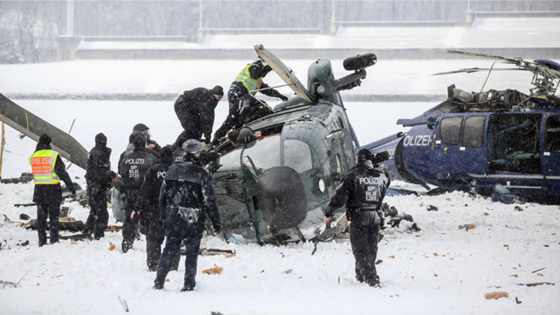 March 21, 2013: Rescue workers examine two crashed helicopters of the German federal police on a field at the Olympic Stadium in Berlin, Germany.
