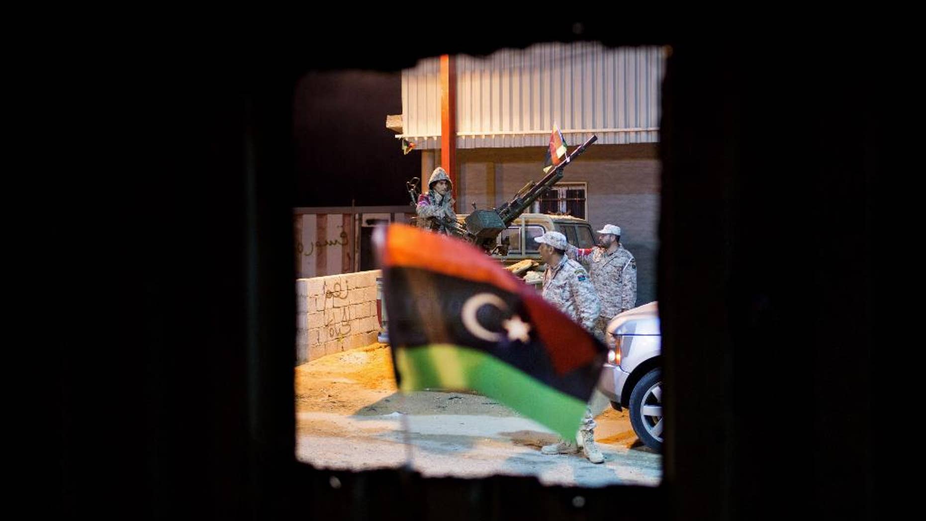 In this Wednesday, Feb. 18, 2015 photo, Libyan military soldiers stand guard, east of the city of Misrata, Libya. (AP Photo/Mohamed Ben Khalifa)