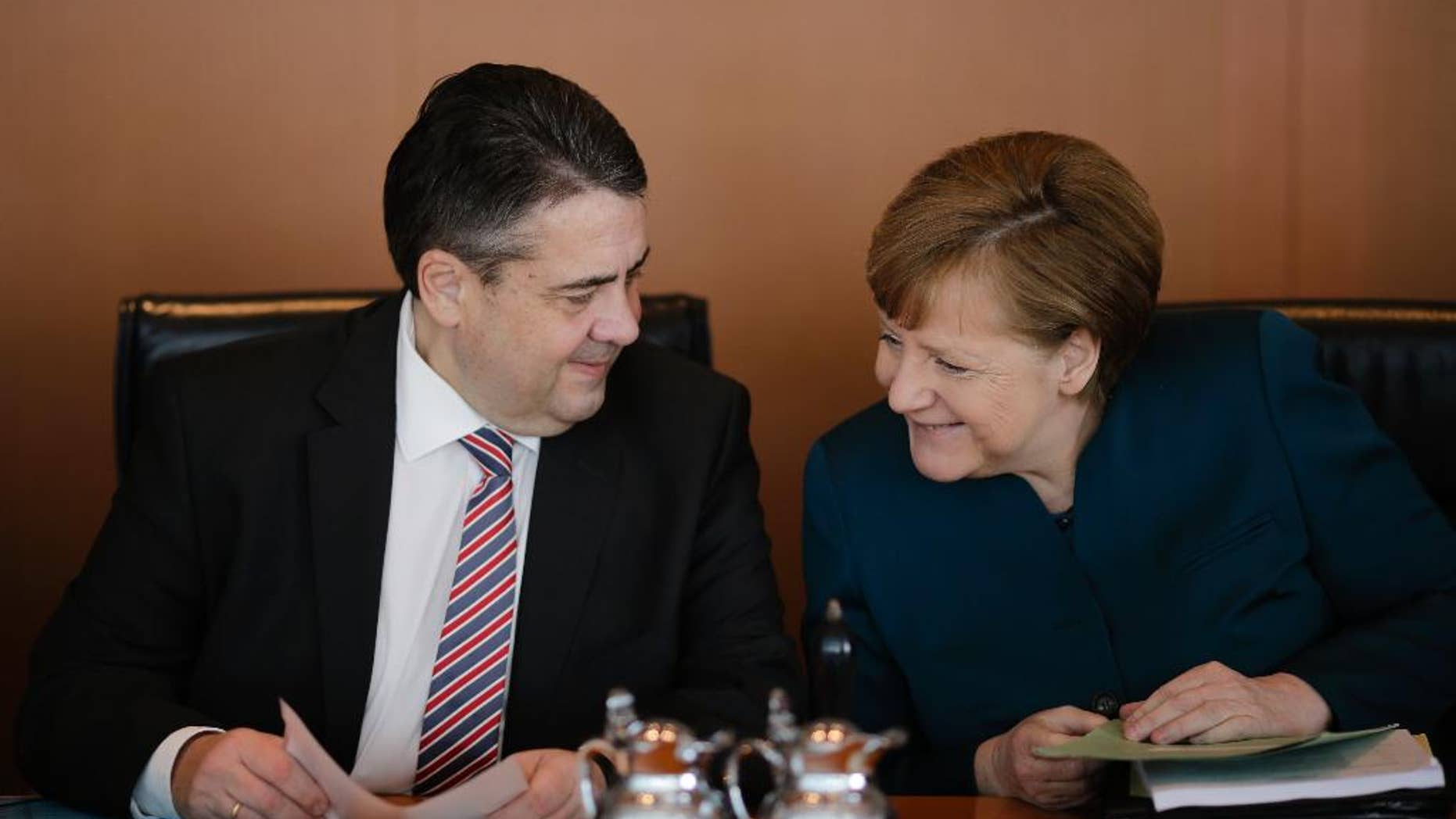 German Chancellor Angela Merkel, right, talks to Foreign Minister and Vice Chancellor Sigmar Gabriel prior to the weekly cabinet meeting of the German government at the chancellery in Berlin, Wednesday, March 22, 2017. (AP Photo/Markus Schreiber)