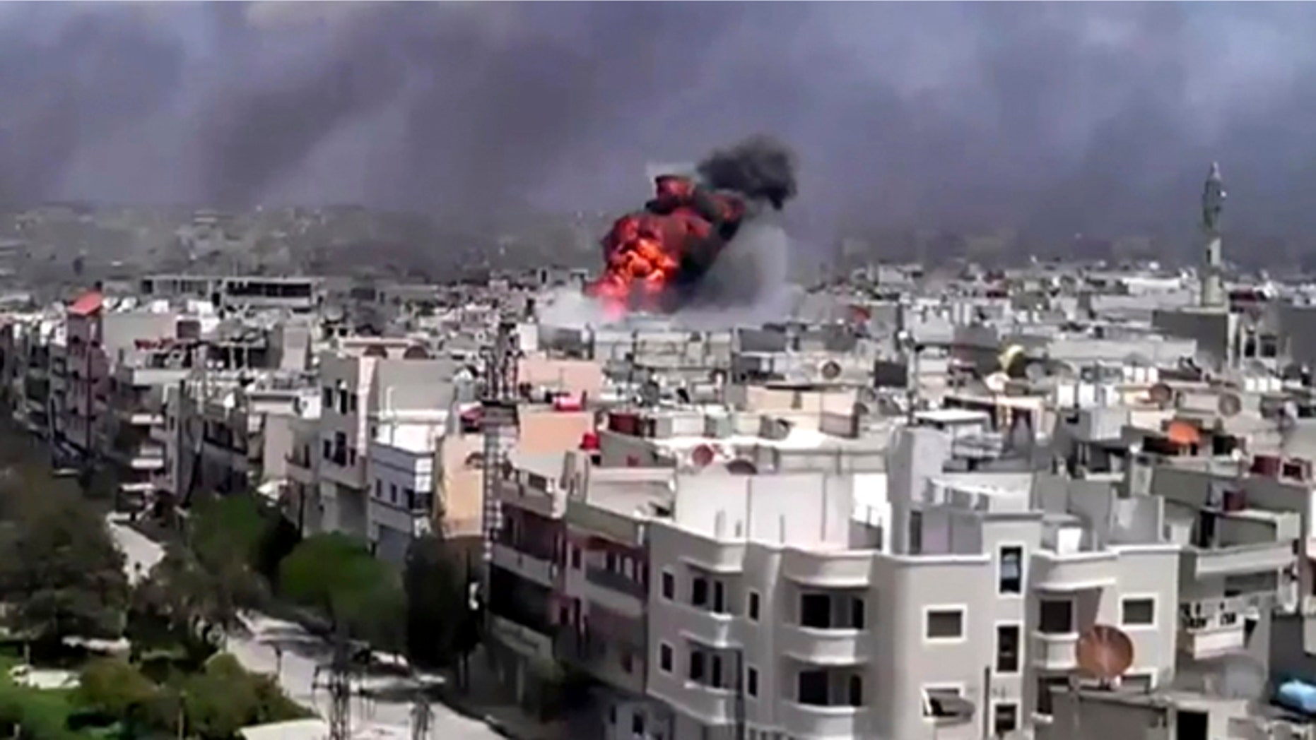 April 20: This image made from amateur video and released by Shaam News Network purports to show an explosion amid heavy shelling in the Khaldiyeh area of Homs, Syria.