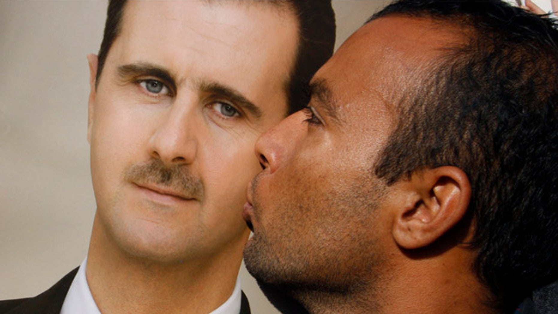 Jan. 4, 2012: A pro-Syrian regime protester kisses a portrait of Syrian President Bashar Assad during a demonstration in support of their President, in Damascus, Syria.