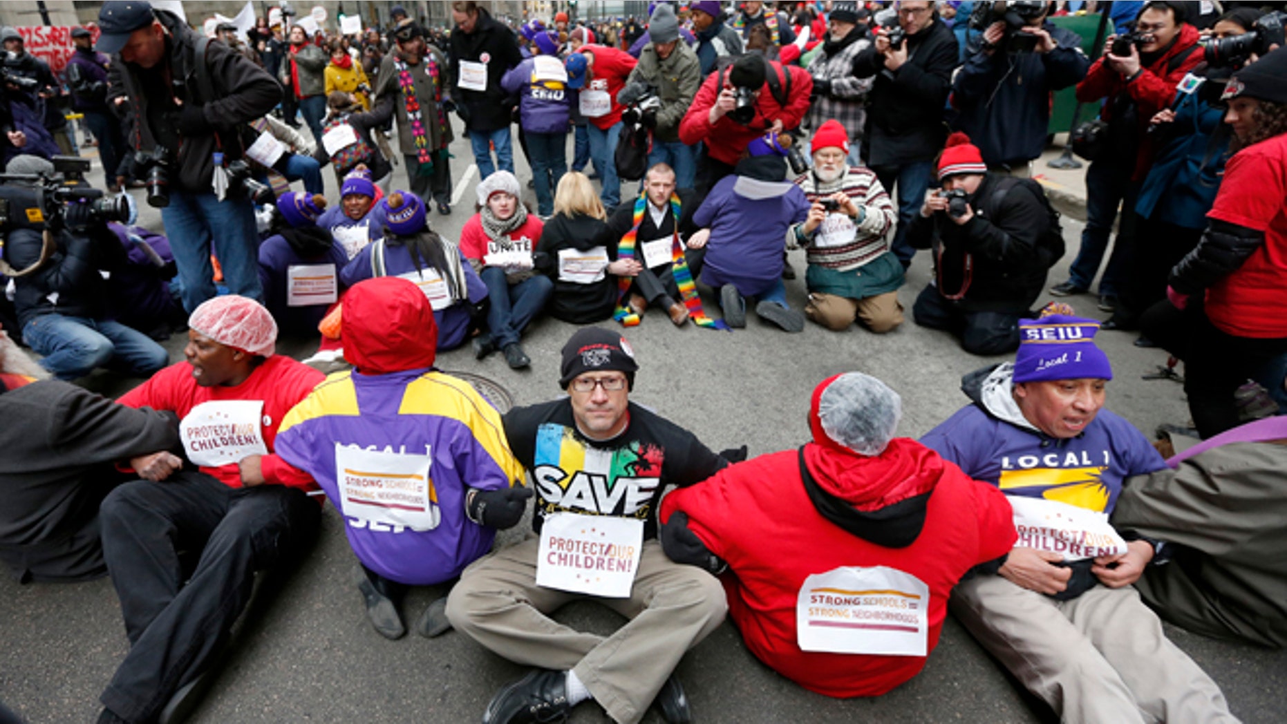 March 27, 2013: Protesters sit on LaSalle Street during an act of civil disobedience over a plan to close 54 Chicago Public Schools in Chicago's downtown.