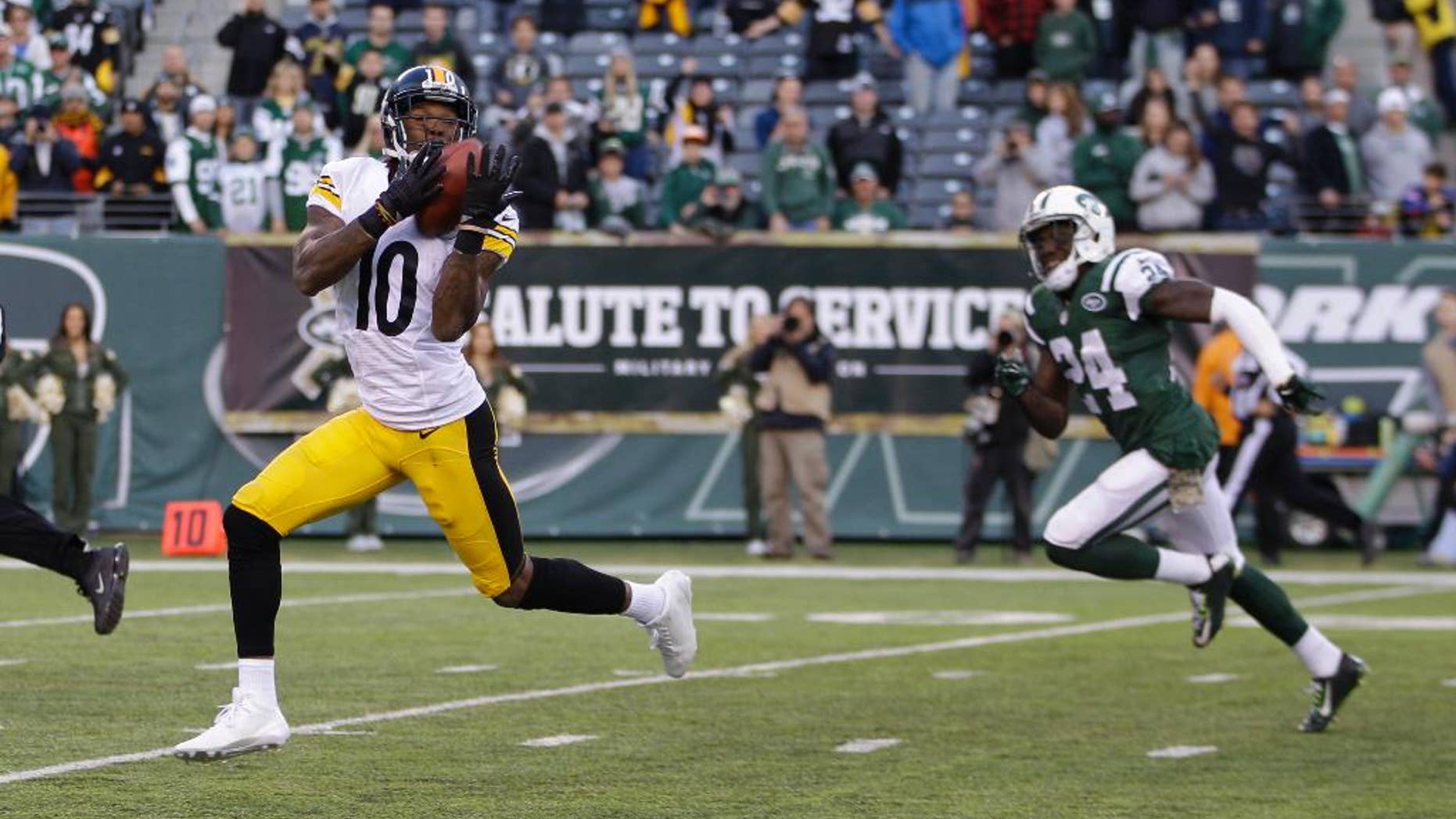 Pittsburgh Steelers wide receiver Martavis Bryant (10) catches a pass for in front of Phillip Adams (24) during the second half of an NFL football game, Sunday, Nov. 9, 2014, in East Rutherford, N.J. Bryant scored a touchdown on the play. (AP Photo/Kathy Willens)
