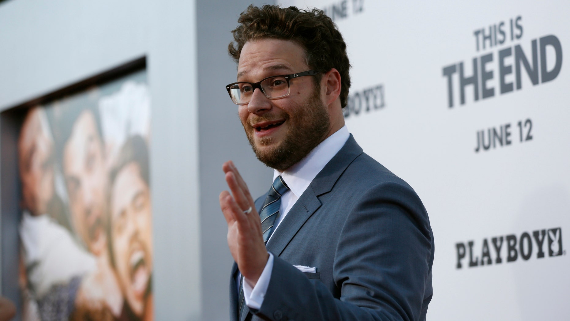 Director, writer and cast member Seth Rogen waves at the premiere of "This Is the End" at the Regency Village Theatre in Los Angeles, California June 3, 2013. The movie opens in the U.S. on June 12. REUTERS/Mario Anzuoni (UNITED STATES - Tags: ENTERTAINMENT) - RTX10AWD