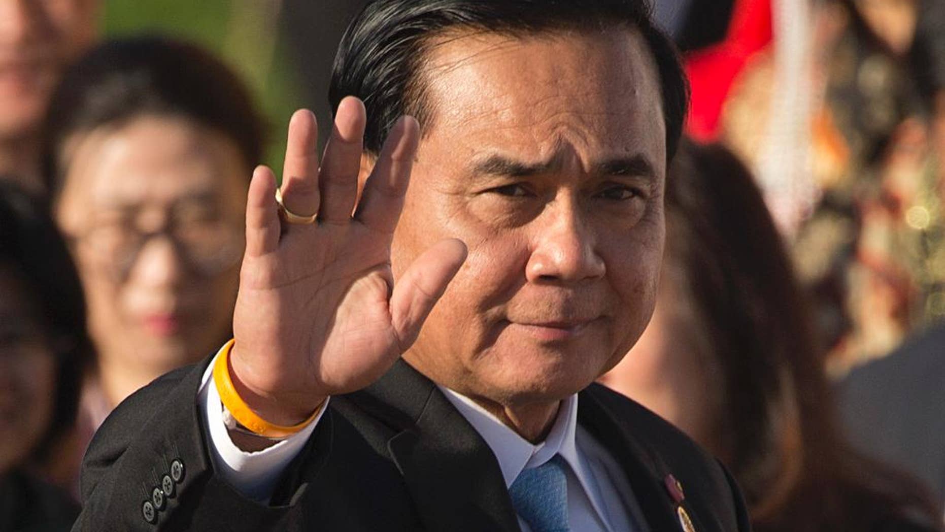 FILE - In this Saturday, July 16, 2016, file photo, Thailand's Prime Minister Prayuth Chan-ocha waves as he arrives for a group photo of leaders at the 11th Asia-Europe Meeting (ASEM) in Ulaanbaatar, Mongolia. On Wednesday, Prime Minister Prayuth defended the military detention of "so-called political prisoners," saying they are given good housing and food, but that they sometimes complain about things like the quality of air conditioning. (AP Photo/Mark Schiefelbein, File)