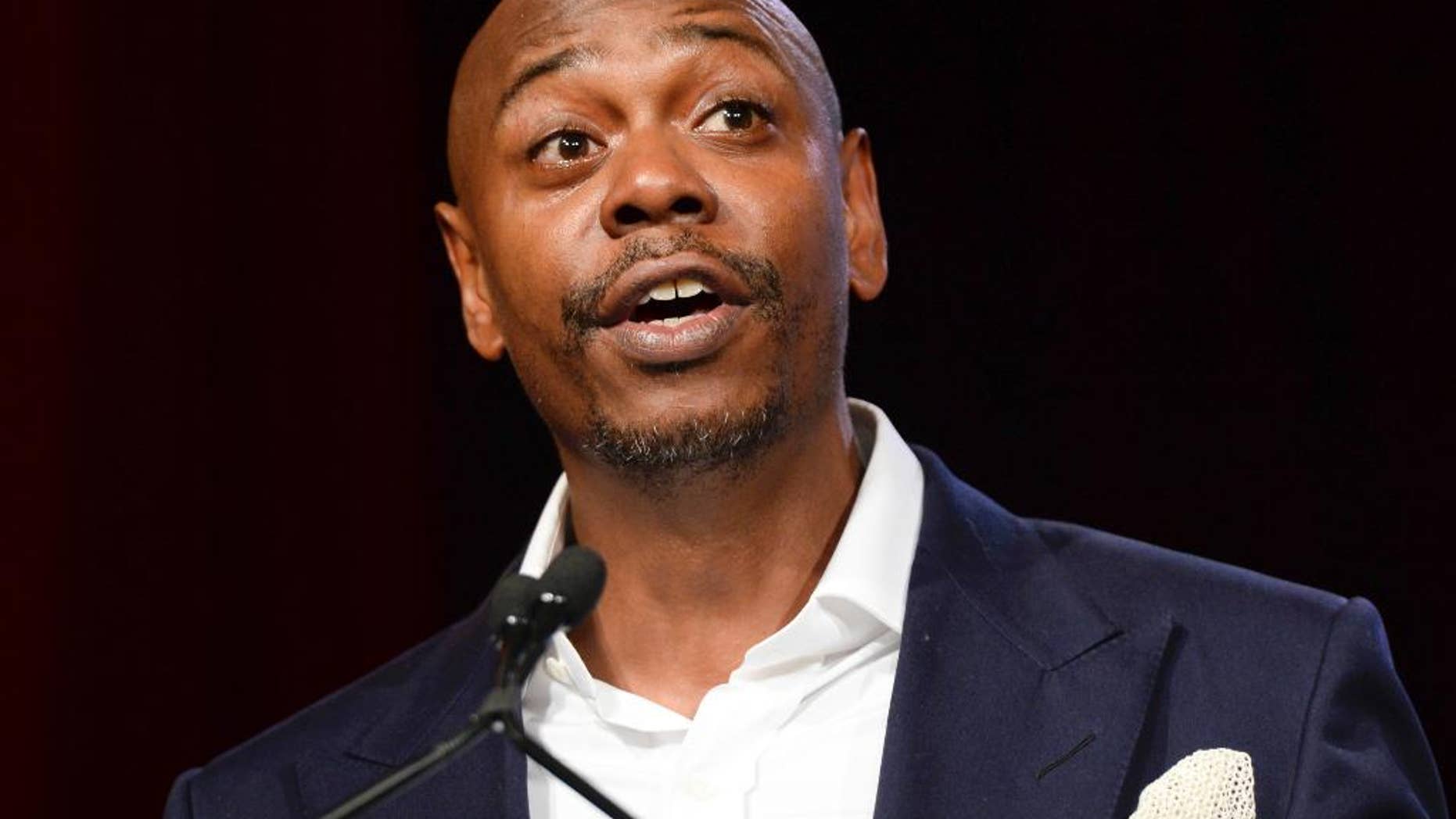 FILE - In this July 18, 2015 file photo, comedian Dave Chappelle speaks at the RUSH Philanthropic Arts Foundation's Art for Life Benefit in New York. Chappelle is set to host NBC’s “Saturday Night Live” on Nov. 12, marking his debut appearance on the show. He will be joined by hip-hop group A Tribe Called Quest. (Photo by Scott Roth/Invision/AP, File)