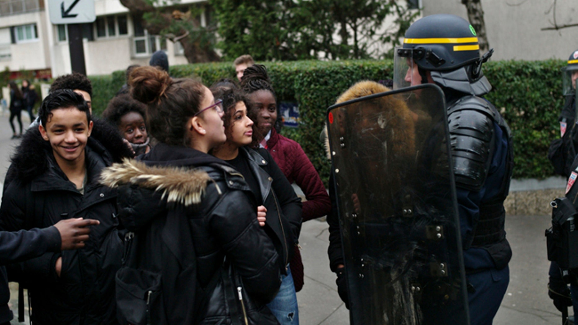 Students talk with a riot police officer as they protest against alleged police abuses in front of the Henri Bergson college, in Paris, Thursday, Feb. 23, 2017. (AP Photo/Thibault Camus)
