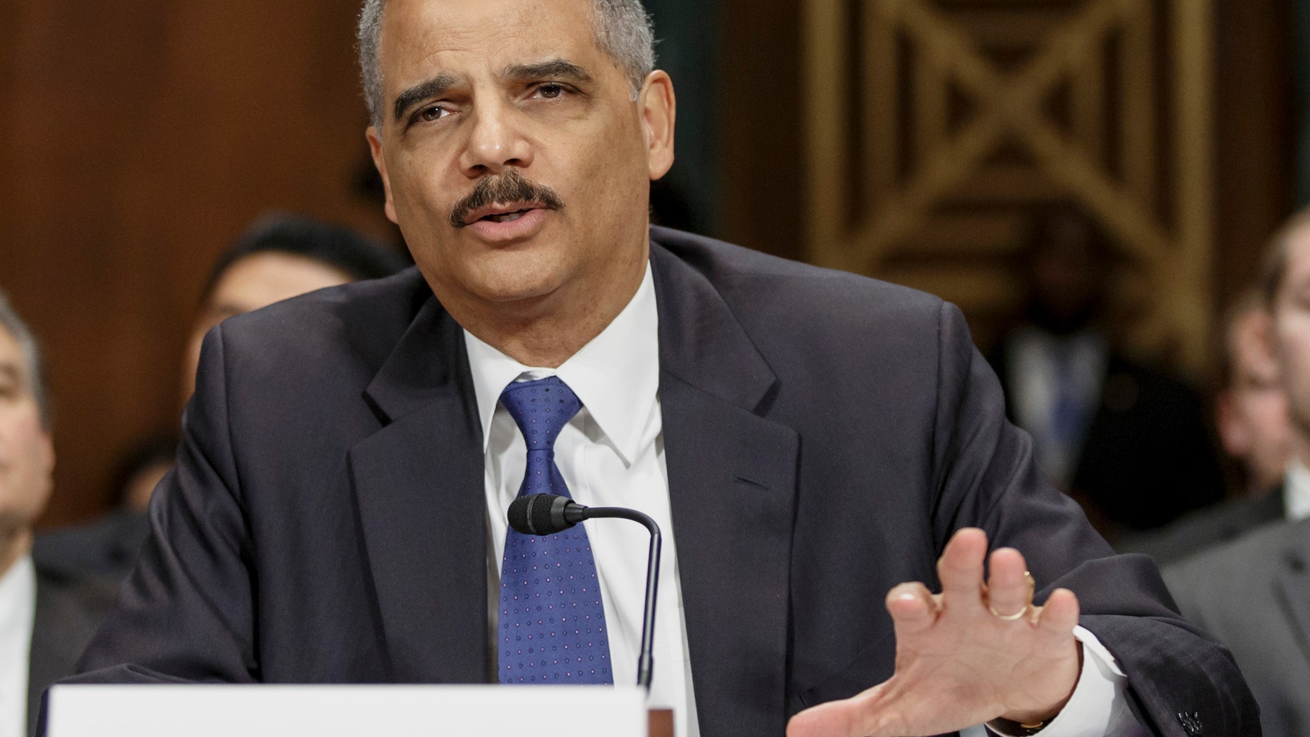 FILE - In this Jan. 29, 2014, file photo, Attorney General Eric Holder testifies on Capitol Hill in Washington. The Justice Department announced Feb. 21, 2014, it is revising its rules for obtaining records from the news media in leak investigations, promising that in most instances the government will notify news organizations beforehand of its intention to do so. The revised procedures are designed to give news organizations an opportunity to challenge any subpoenas or search warrants in federal court. (AP Photo/J. Scott Applewhite, File)