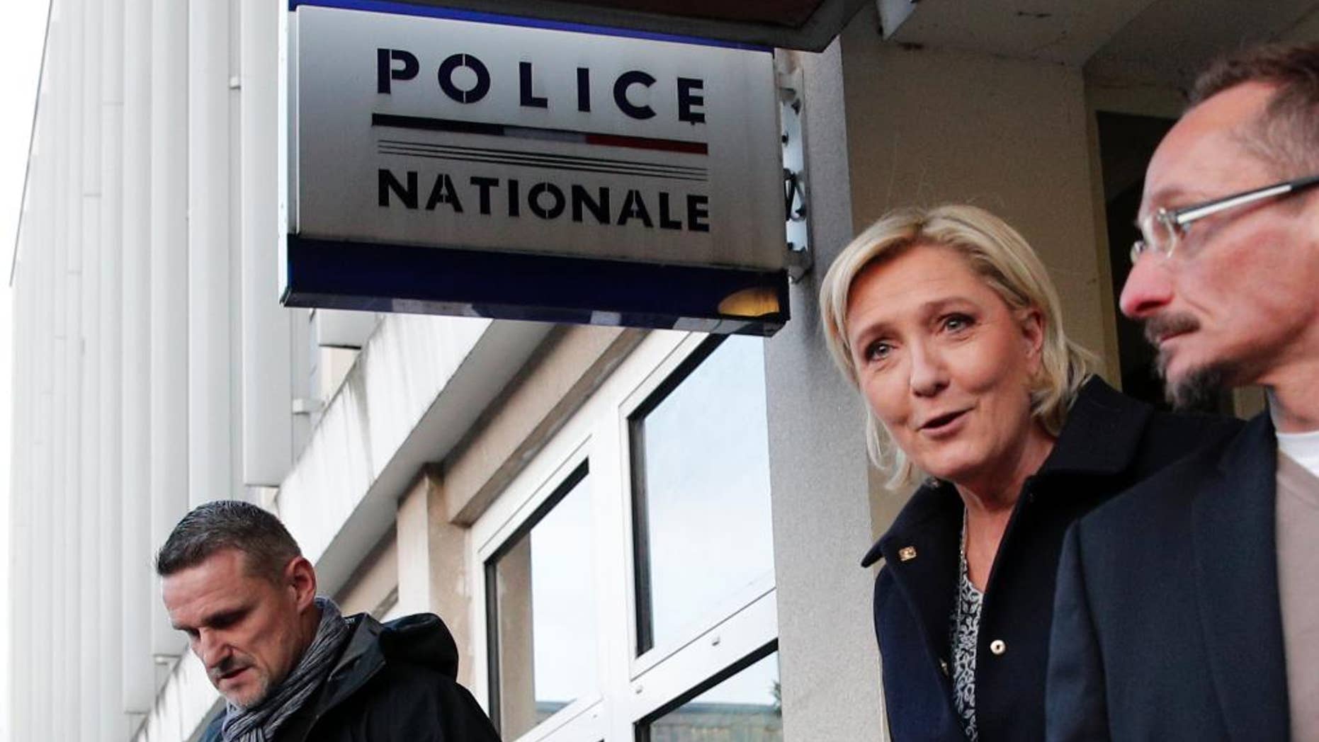 French far-right presidential candidate Marine Le Pen leaves after a meeting at the Juvisy-sur-Orge police station, south of Paris, France, as she campaigns for the upcoming presidential election, Tuesday, Feb. 7, 2017. (AP Photo/Christophe Ena)