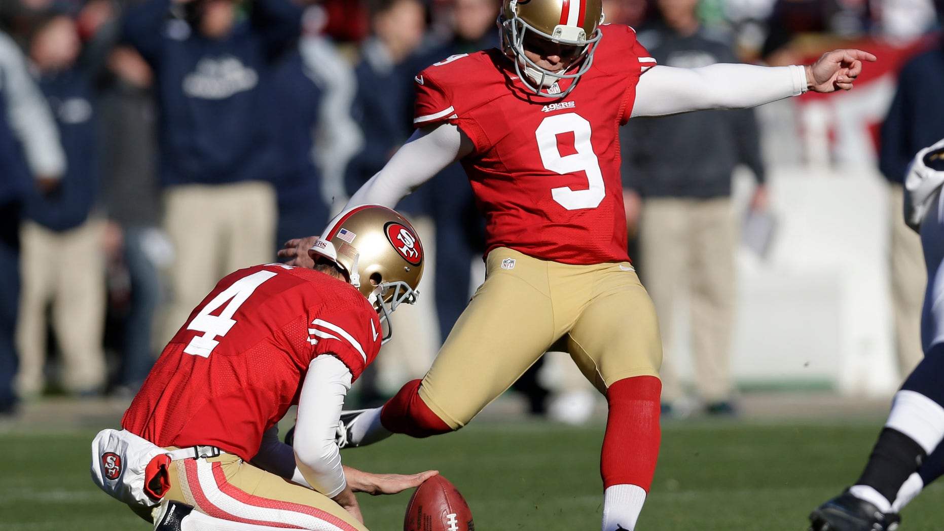 San Francisco 49ers kicker Phil Dawson (9) boots a field goal as Andy Lee, left, holds the ball in the first half of an NFL football game against the Seattle Seahawks, Sunday, Dec. 8, 2013, in San Francisco. (AP Photo/Marcio Jose Sanchez)
