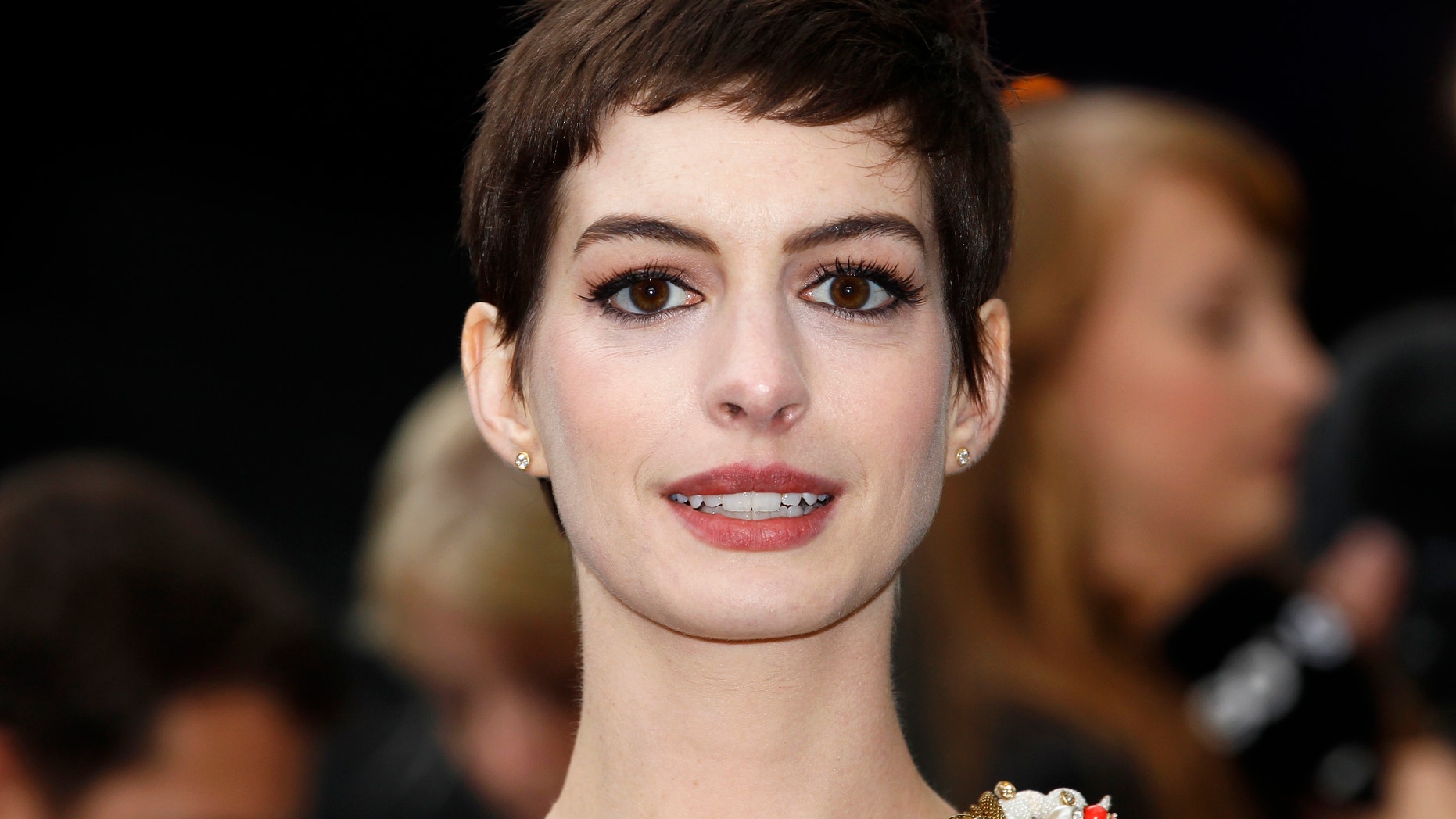 Actress Anne Hathaway poses for photographers as she arrives at a premiere in London.
