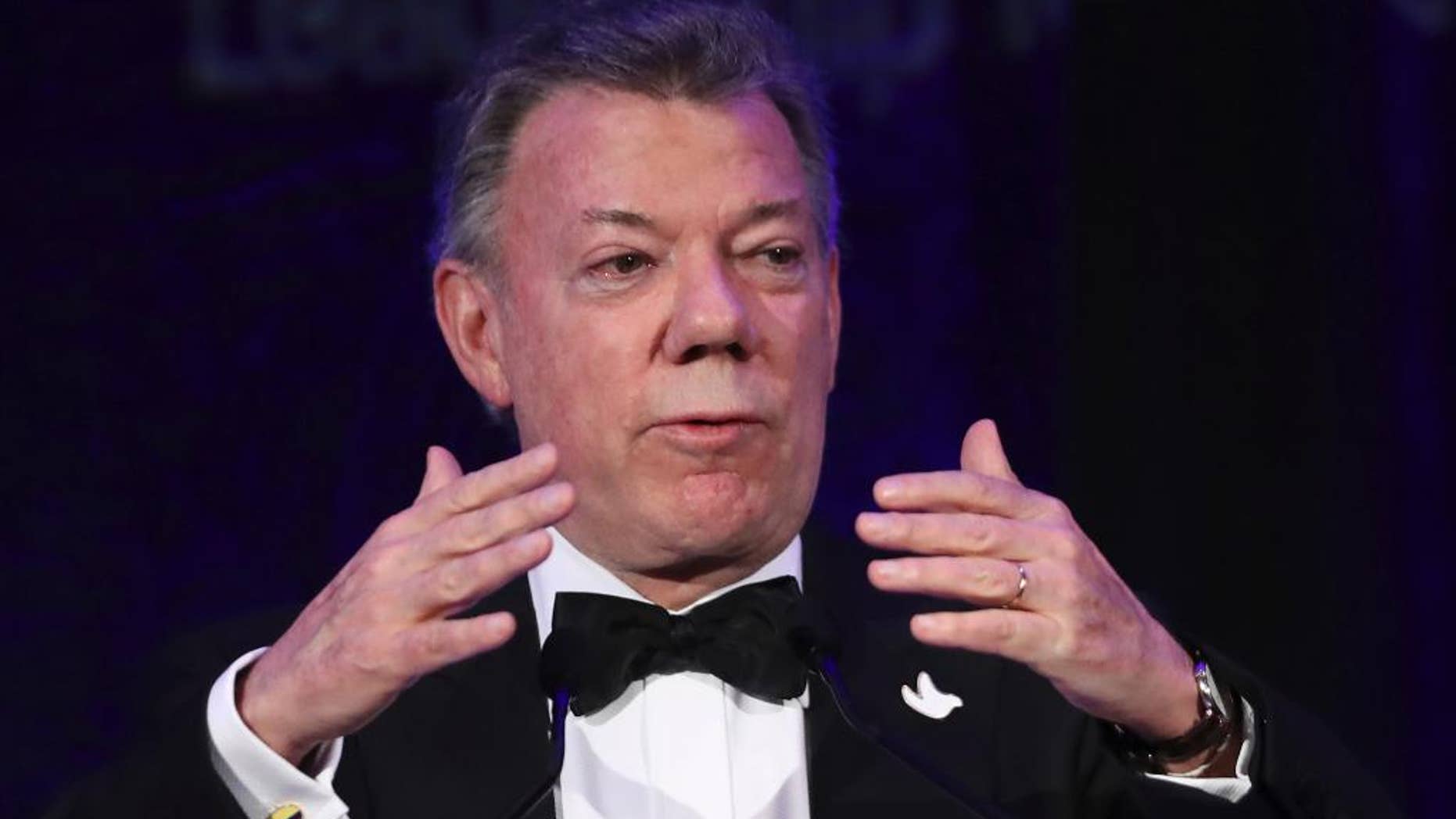 Colombian President Juan Manuel Santos, recipient of the 2016 Nobel Peace Prize, speaks after accepting the Inter-American Dialogue's Leadership for the Americas Award at the institution's annual gala dinner in Washington, Wednesday, Nov. 16, 2016. (AP Photo/Manuel Balce Ceneta)