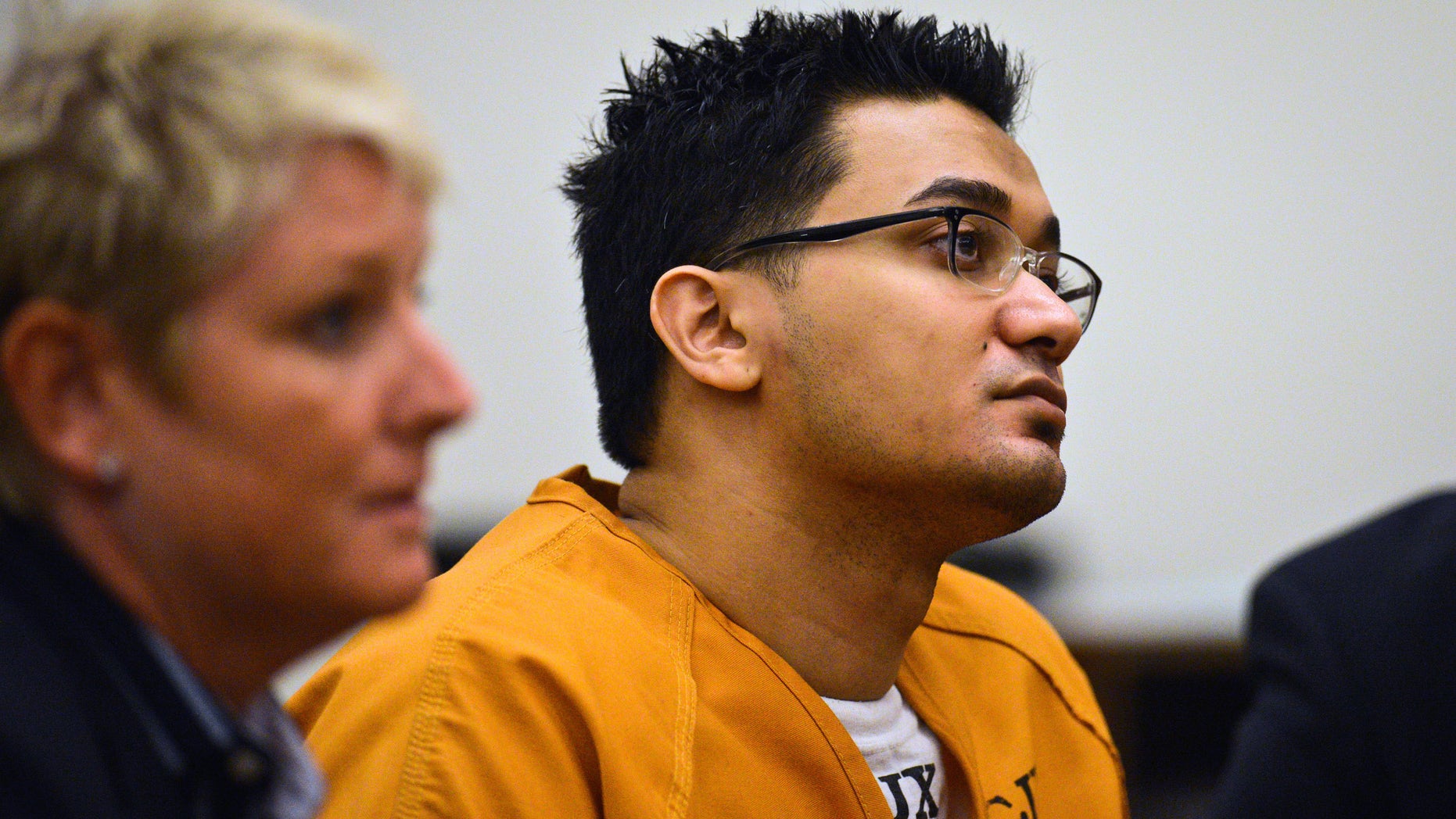 FILE - In this Aug. 9, 2013 file photo, Iftekhar Murtaza listens during a hearing in Orange County Superior Court in Santa Ana, Calif. Murtaza, a murder suspect, has been admonished by a California judge for speaking out during the testimony of a witness about a 2007 attack she survived at her home during his trial. The incident occurred as Leela Dhanak testified in Murtaza’s trial on charges of attacking her and killing her husband and elder daughter. (AP Photo/Orange County Register, Mackenzie Reiss,File) MAGS OUT; LOS ANGELES TIMES OUT
