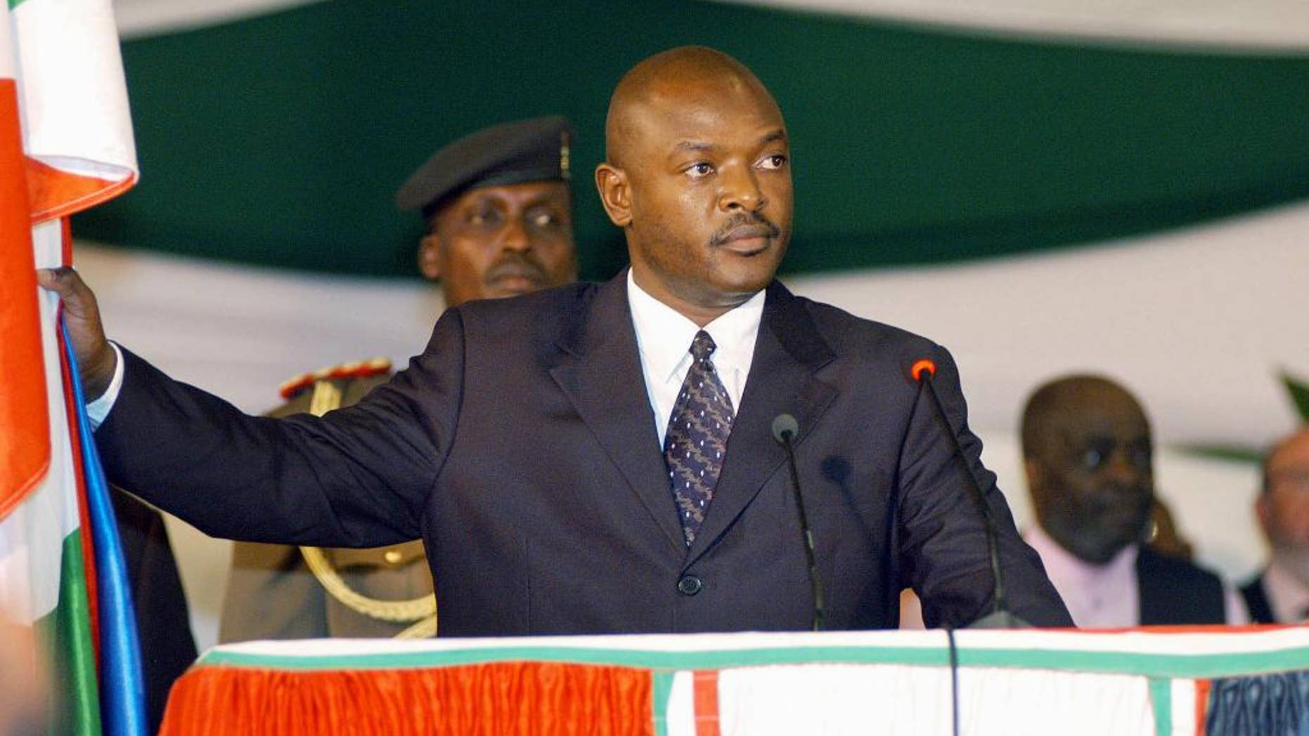 FILE - In this Aug. 26 2005 file photo, Burundi's president, Pierre Nkurunziza stands as he takes the presidential oath in parliament in the capital, Bujumbura, Burundi. Burundi's re-elected president is urging unity after winning contentious polls that the international community says were not credible. In a televised speech on Thursday, July 30, 2015, Pierre Nkurunziza said he would be a president for all, including those who did not vote for him. (AP Photo/Riccardo Gangale, File)