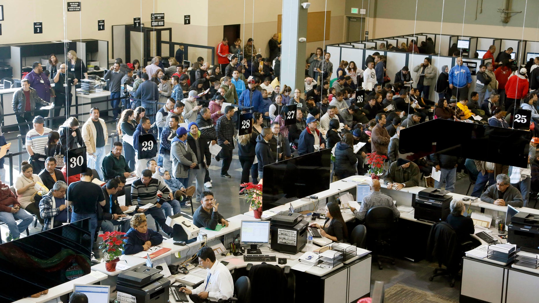 Immigrants line up at a California Department of Motor Vehicles in Stanton, Calif., Friday, Jan. 2, 2015.