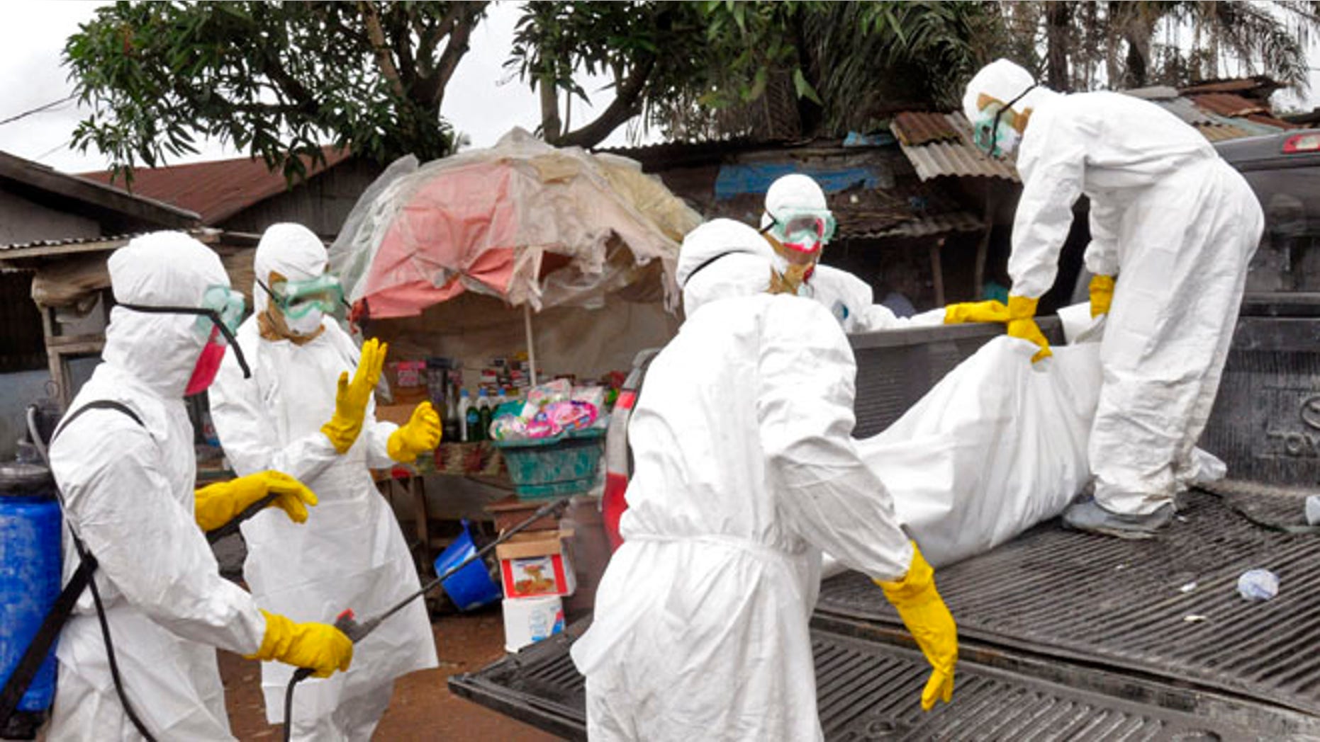 Sept. 10, 2014: Health workers load the body of a woman they suspect died from the Ebola virus onto a truck in Monrovia, Liberia.