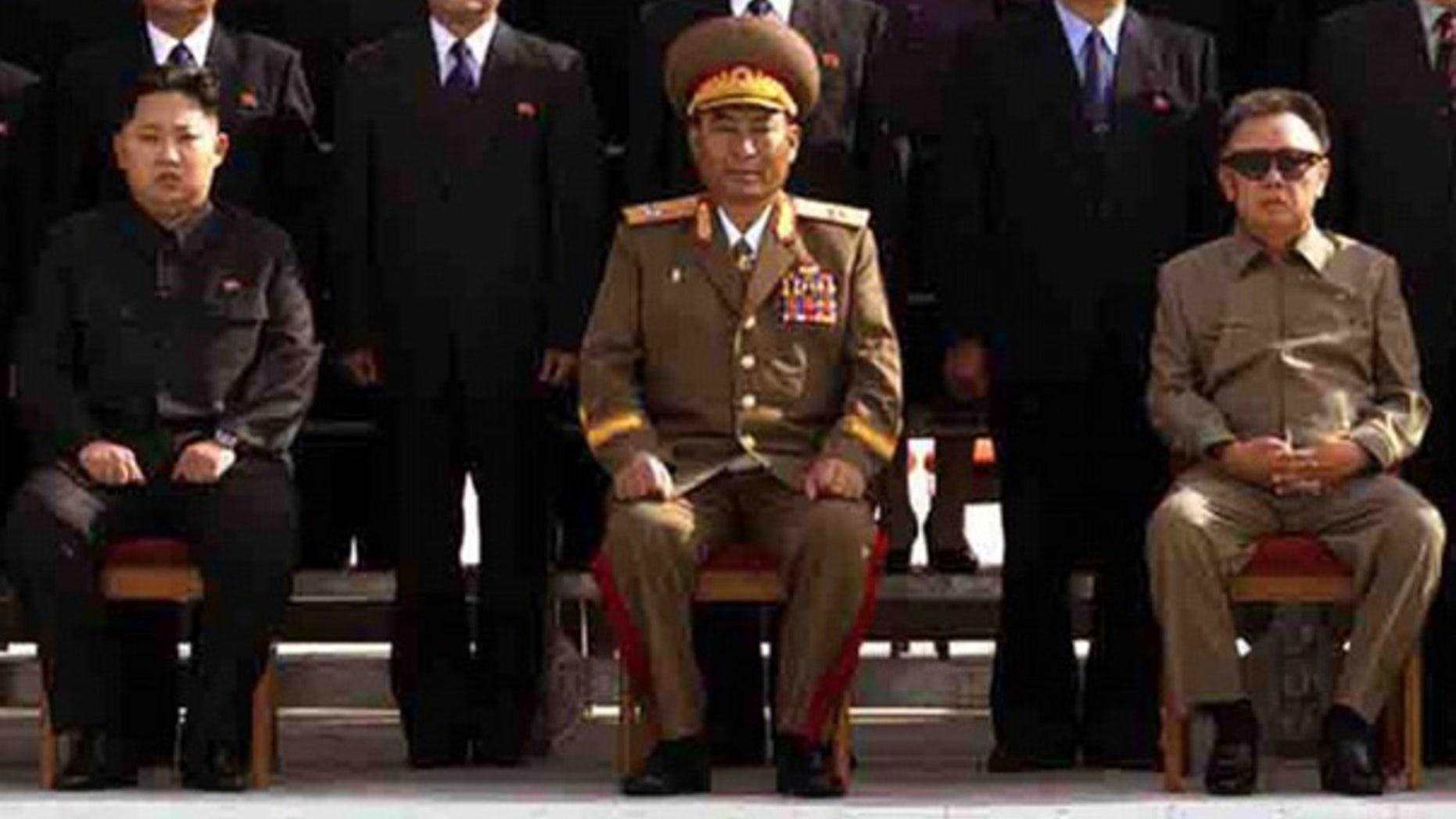 Released Sept. 30: Kim Jong Un, left, the youngest son of North Korean leader Kim Jong Il, right, poses with newly elected members of the Workers' Party of Korea. (Best quality available)