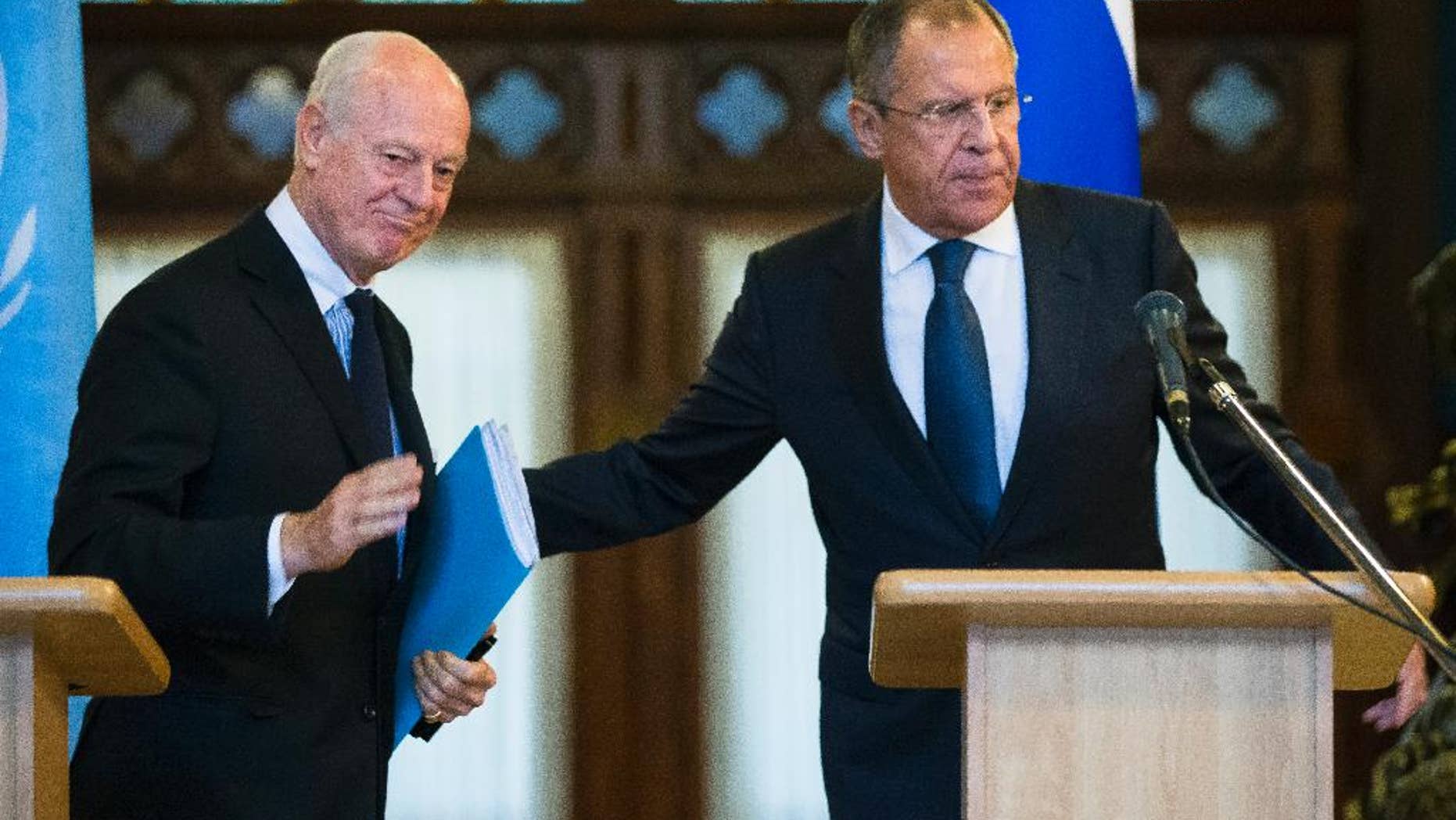 Russian Foreign Minister Sergey Lavrov, right, and U.N. Special Envoy for Syria Staffan de Mistura leave a news conference following their talks in Moscow, Russia, Wednesday, Nov. 4, 2015. Lavrov says he hopes that international peacebrokers in the coming days will agree on the list of opposition groups that should be invited to peace talks. (AP Photo/Alexander Zemlianichenko)