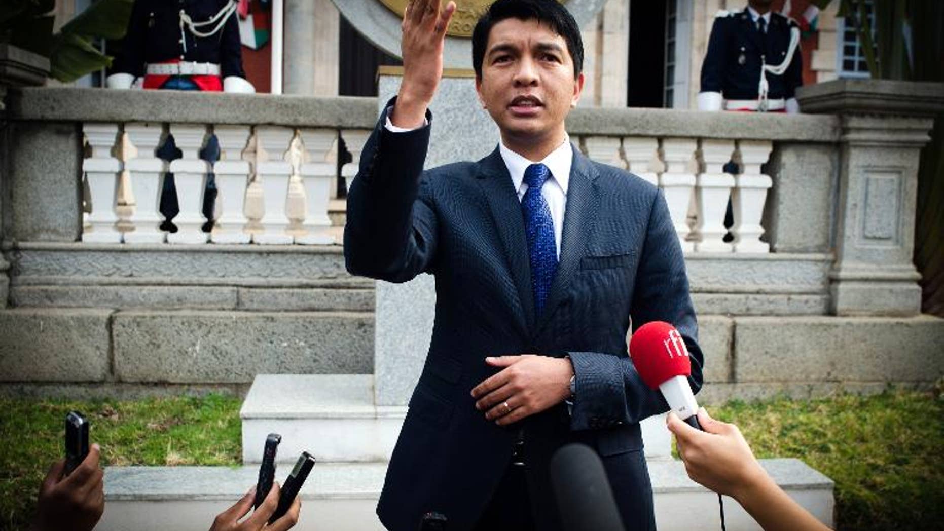 Madagascar strongman Andry Rajoelina answers journalists on September 30, 2013 outside the presidentential palace in Antananarivo