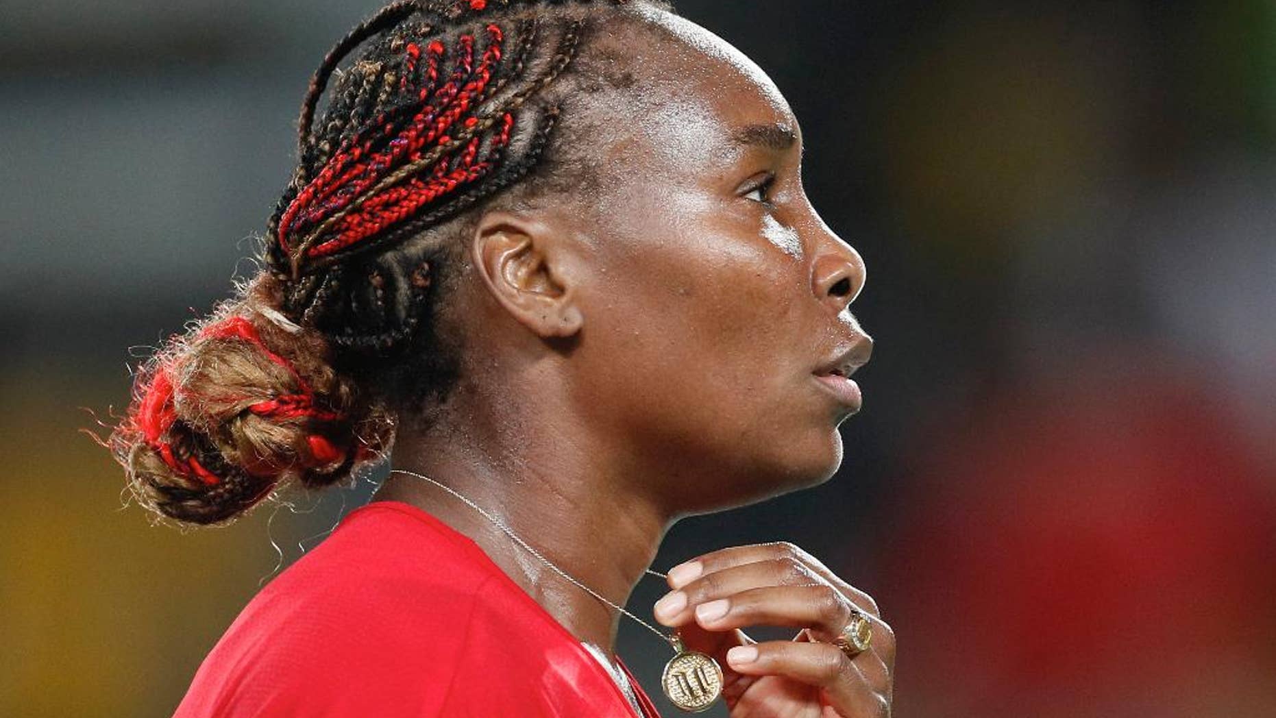 Venus Williams holds her medallion after losing a point to Belgium's Kirsten Flipkens in the women's tennis competition at the 2016 Summer Olympics in Rio de Janeiro, Brazil, Saturday, Aug. 6, 2016. (AP Photo/Vadim Ghirda)