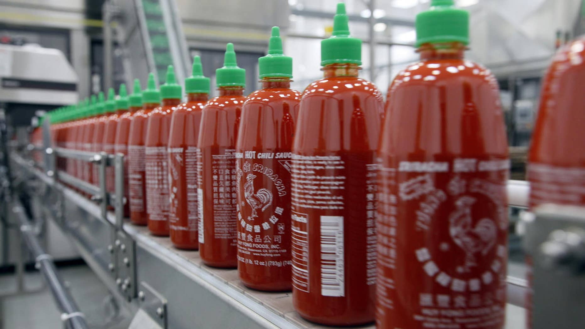 Sriracha chili sauce heads down the conveyor belt at the Huy Fong Foods factory in Irwindale, Calif.