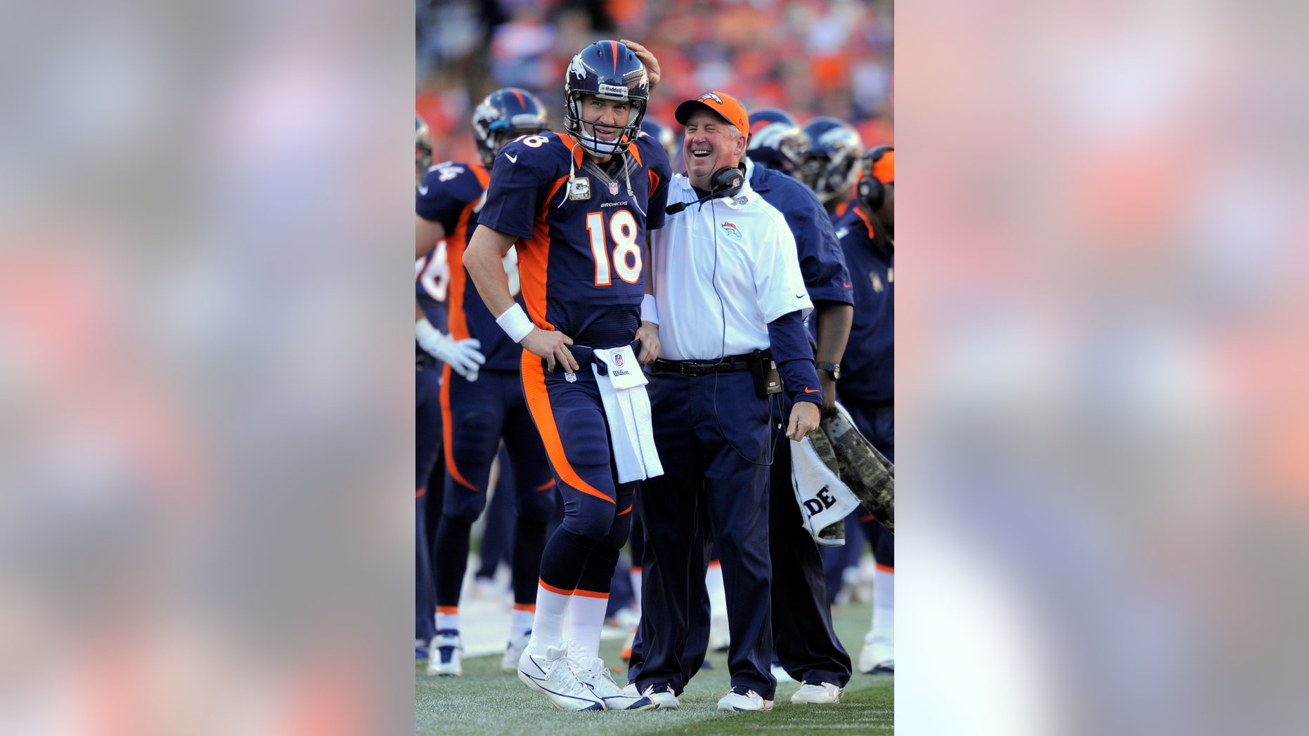 FILE - In this Nov. 17, 2012, file photo, Denver Broncos quarterback Peyton Manning (18) looks on as head coach John Fox celebrates during an NFL football game between the Denver Broncos and the San Diego Chargers in Denver. The Broncos have reeled off nine consecutive wins after a 2-3 start. (AP Photo/Jack Dempsey, File)