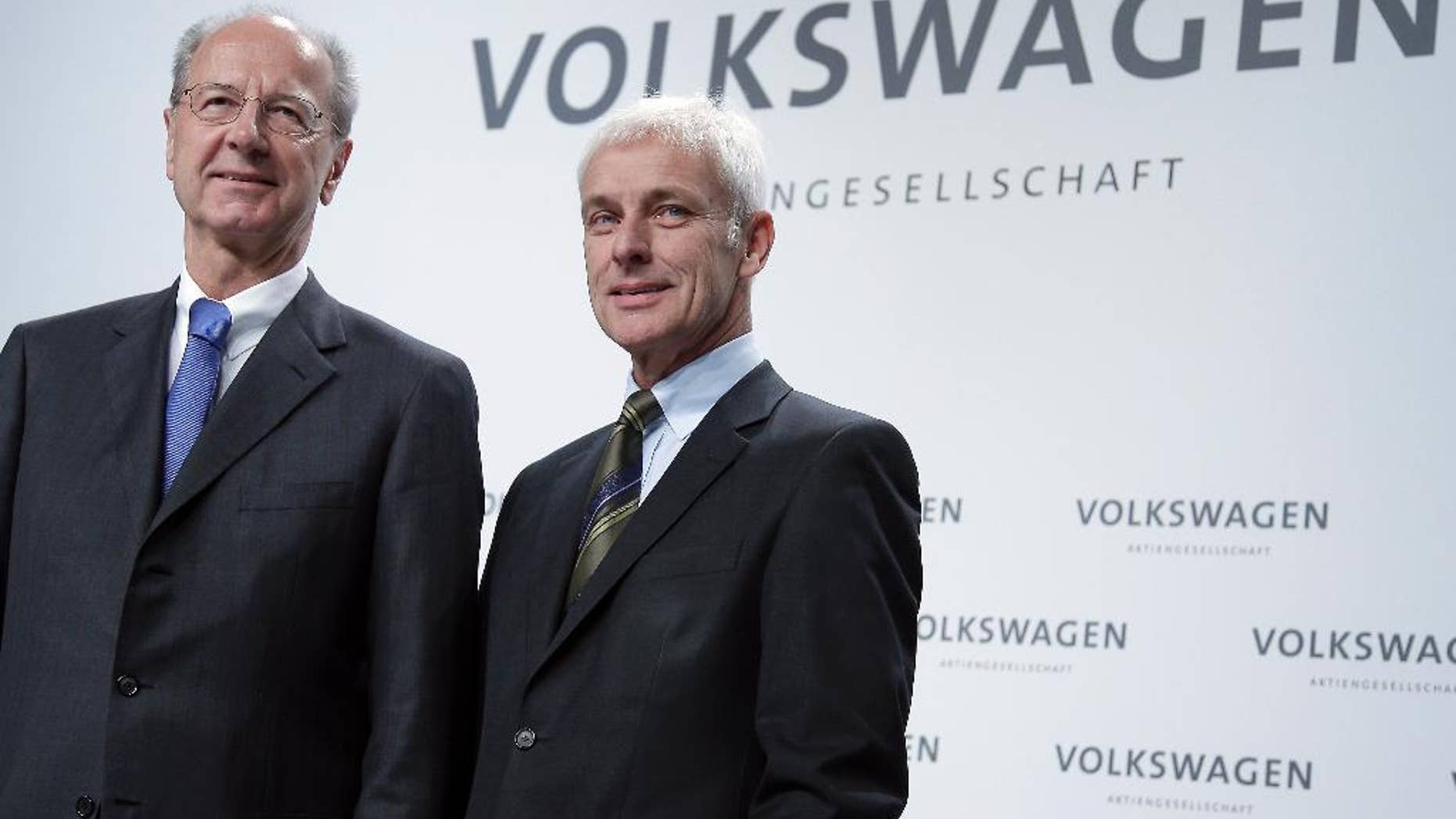 Hans Dieter Poetsch, chairman of the board of directors of Volkswagen, left, and Matthias Mueller, CEO of Volkswagen, right, pose for the media prior to a press conference of the German car manufacturer Volkswagen in Wolfsburg, Germany, Thursday, Dec. 10, 2015. (AP Photo/Michael Sohn)