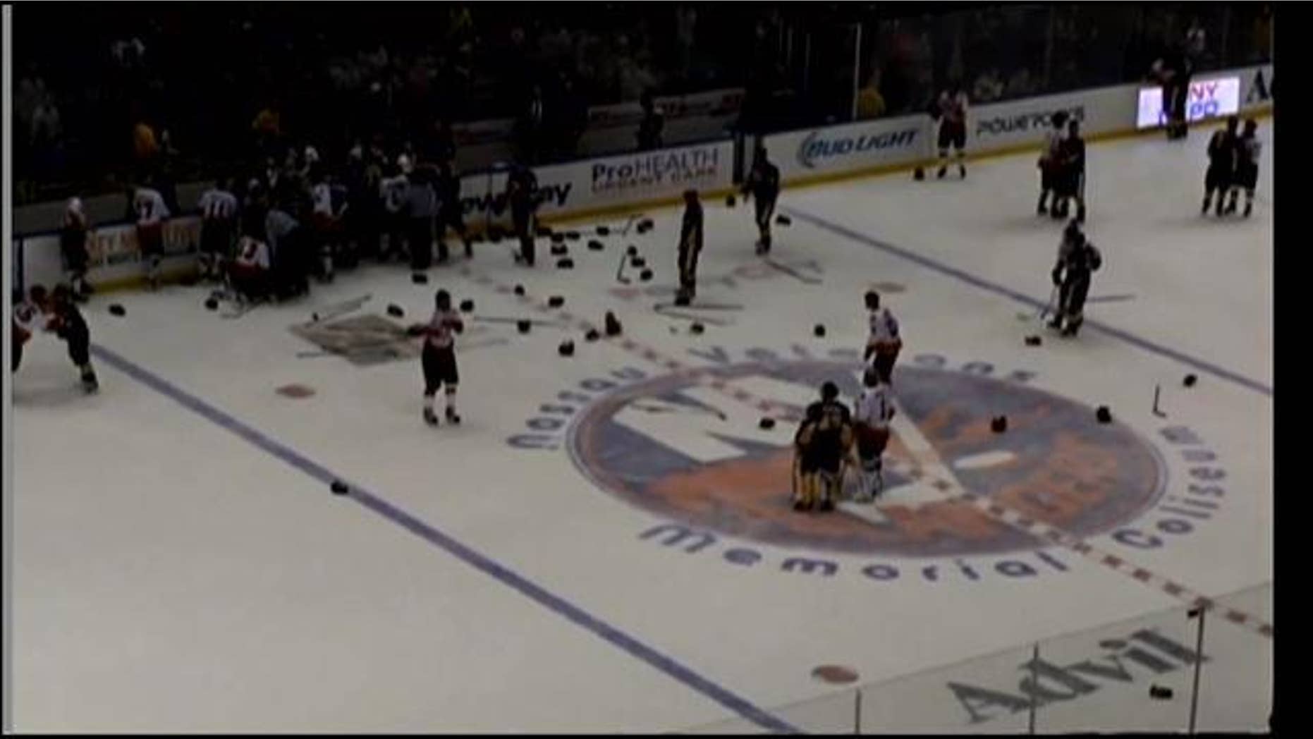 April 6, 2014: Officials try to break up a brawl between hockey teams representing the NYPD and the FDNY at Nassau Coliseum in Uniondale, Long Island (MyFoxNY.com)