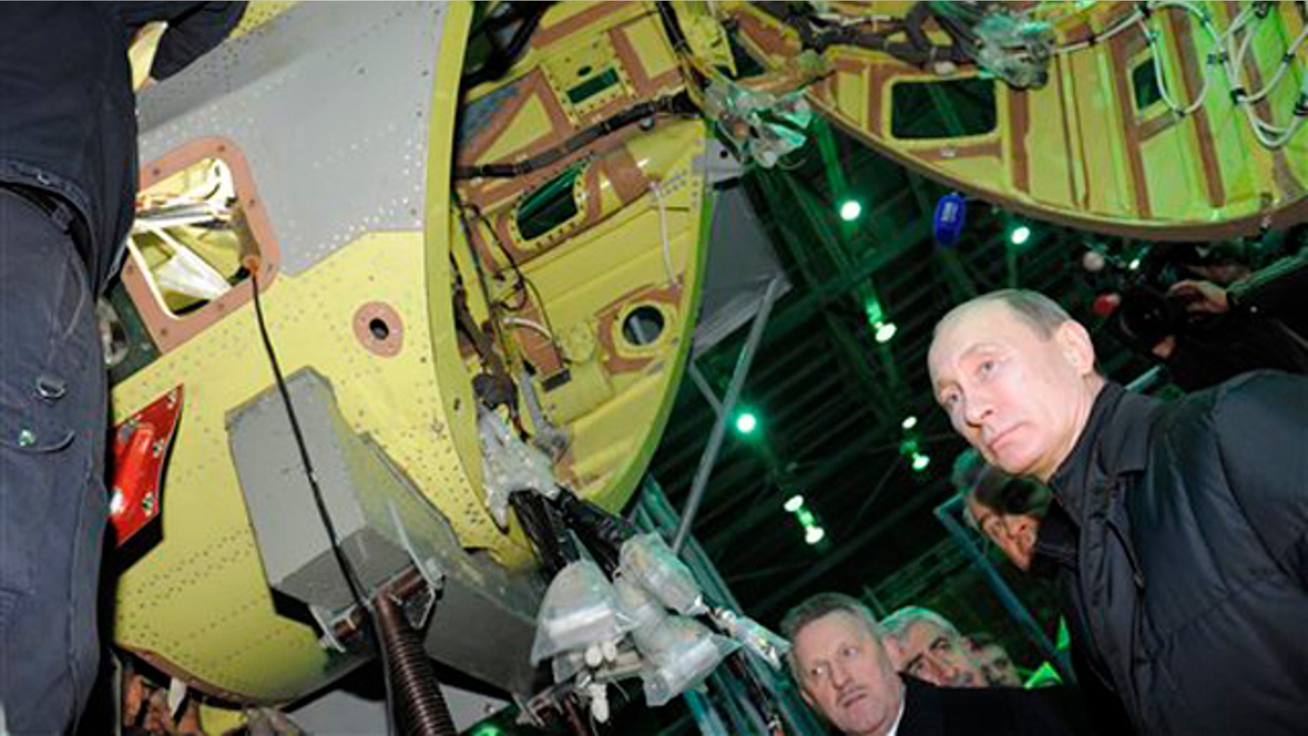 Feb. 20, 2012: Russian Prime Minister and presidential candidate Vladimir Putin, right, listens to an explanation during a visit to Komsomolsk-on-Amur Aircraft Building Corporation in Komsomolsk-on-Amur about 3,900 miles east of Moscow.