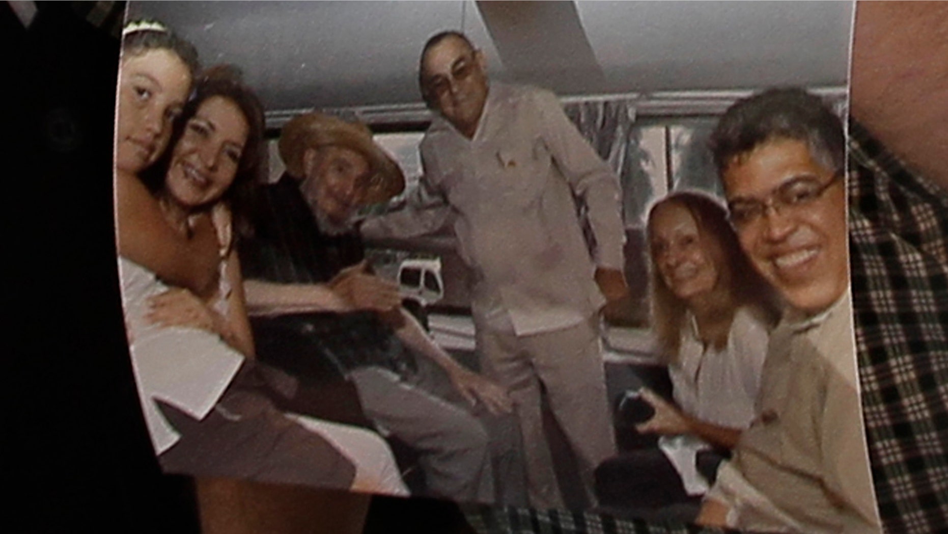 Former Venezuelan Vice President Elias Jaua shows a picture of Cuba's leader Fidel Castro, third from left, at the Hotel Nacional in Havana Sunday Oct. 21, 2012. According to Jaua, the picture was taken Saturday Oct. 20, 2012 inside a van outside the hotel. (AP Photo/Franklin Reyes)