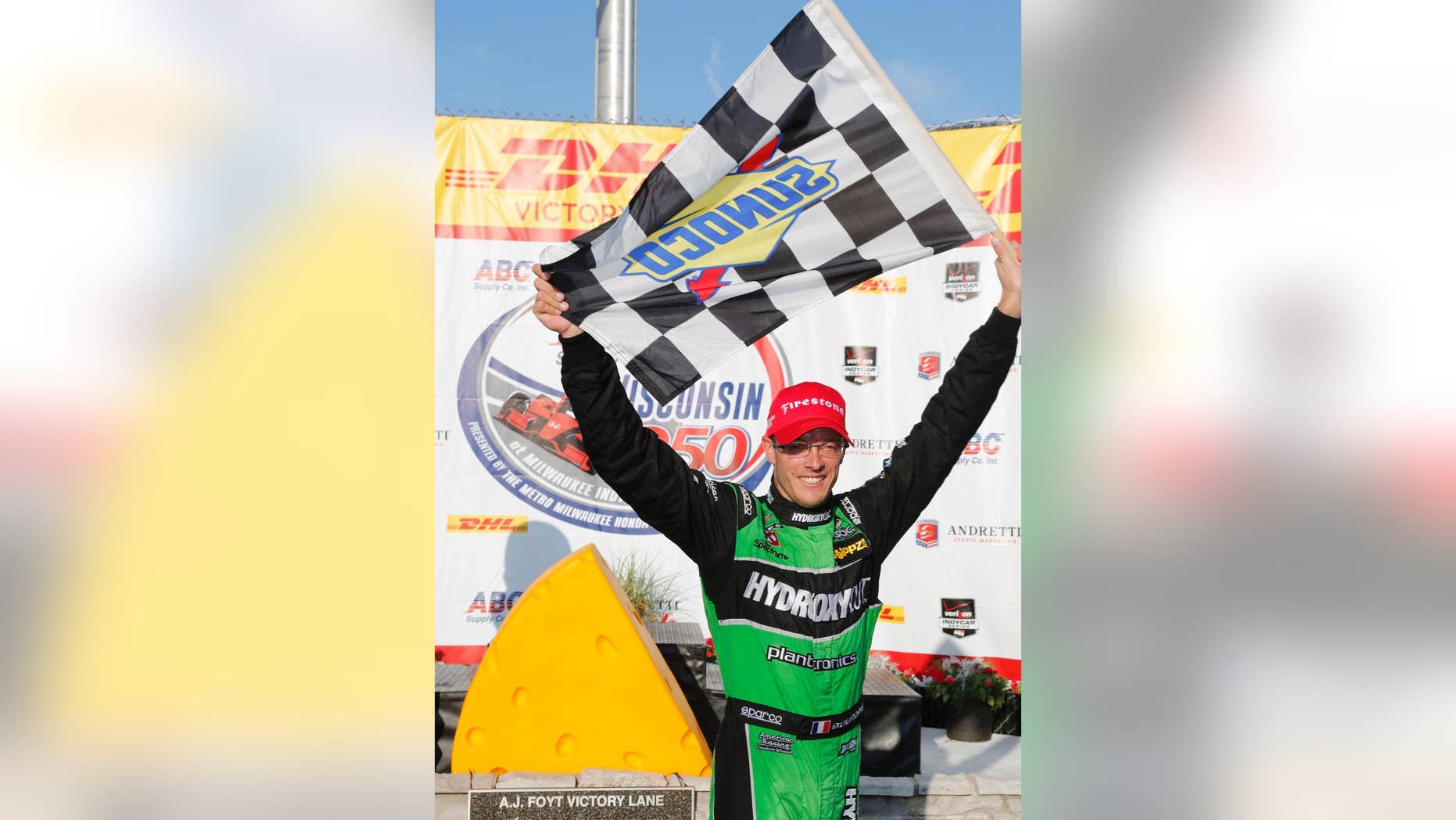Sebastien Bourdais celebrates in the winners circle after the IndyCar Series race at the Milwaukee Mile in West Allis, Wis., Sunday, July 12, 2015. (AP Photo/Jeffrey Phelps)