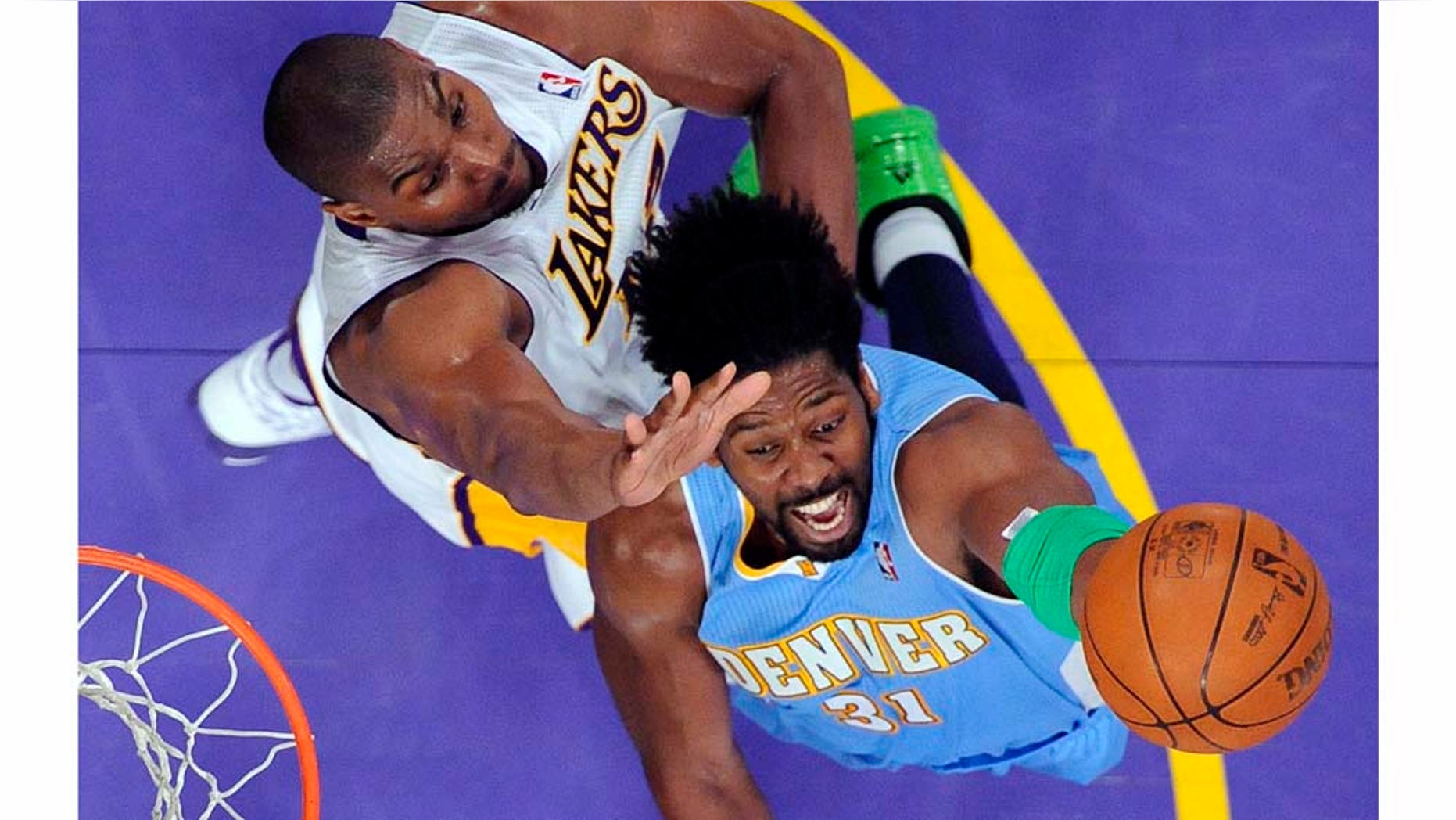 Denver Nuggets center Nene, right, of Brazil, puts up a shot as Los Angeles Lakers center Andrew Bynum defends during the second half of an NBA basketball game, Sunday, April 3, 2011, in Los Angeles. The Nuggets won 95-90. (AP Photo/Mark J. Terrill)