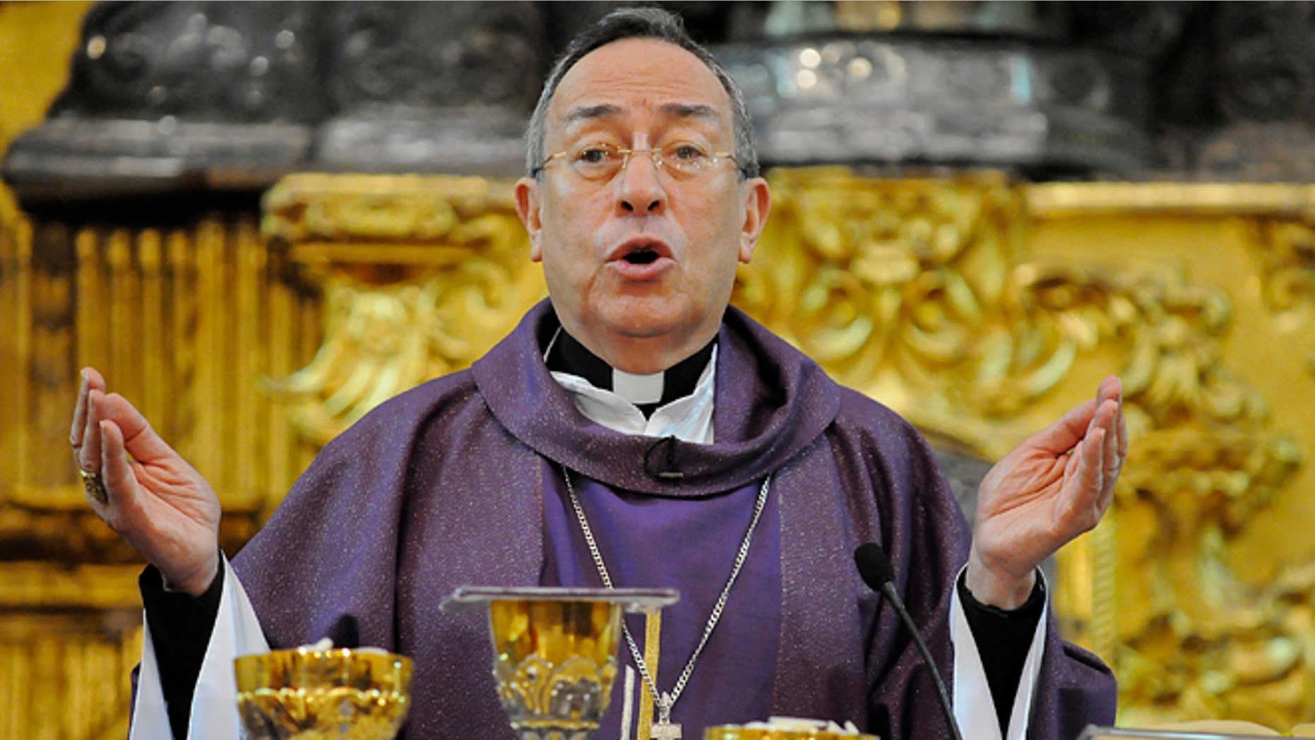 FILE - A Sunday Feb. 24, 2013 photo from files showing Cardinal Oscar Andres Rodriguez Maradiaga, the 70-year-old archbishop of Tegucigalpa, giving mass at the metropolitan cathedral in the city of Tegucigalpa, Honduras. To many, Honduran Cardinal Andres Rodriguez Maradiaga embodies the activist wing of the Roman Catholic Church as an outspoken campaigner of human rights, a watchdog on climate change and advocate of international debt relief for poor nations. Others, however, see him as a reactionary in the other direction: Described as sympathetic to a coup in his homeland and stirring accusations of anti-Semitism for remarks that some believe suggested Jewish interests encouraged extra media attention on church sex abuse scandals. Both images will follow him into the Sistine Chapel conclave along with other cardinals named as possible successors to Pope Benedict XVI. (AP Photo/Fernando Antonio, File)