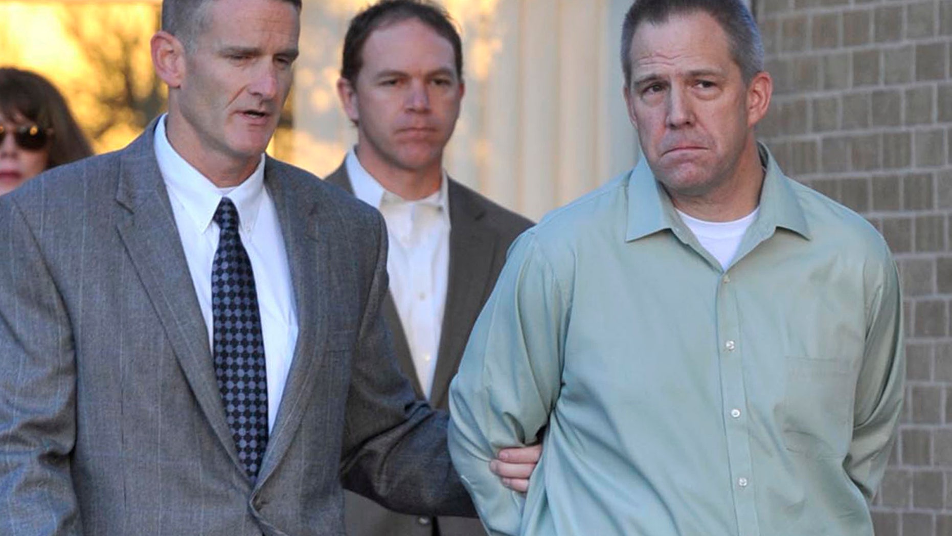 April 2, 2012: In this file photo JetBlue pilot Clayton Frederick Osbon, right, is escorted to a waiting vehicle by FBI agents as he is released from The Pavilion at Northwest Texas Hospital, in Amarillo, Texas.