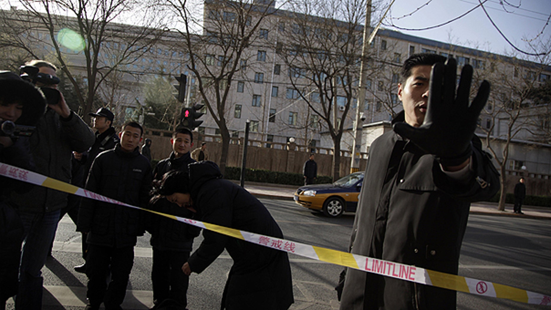 Dec. 10: A plain clothes security person blocks a photographer in an area cordoned off for journalists to work outside the residential compound where Liu Xia, the wife of Nobel Peace Prize winner Liu Xiaobo lives in Beijing, China.