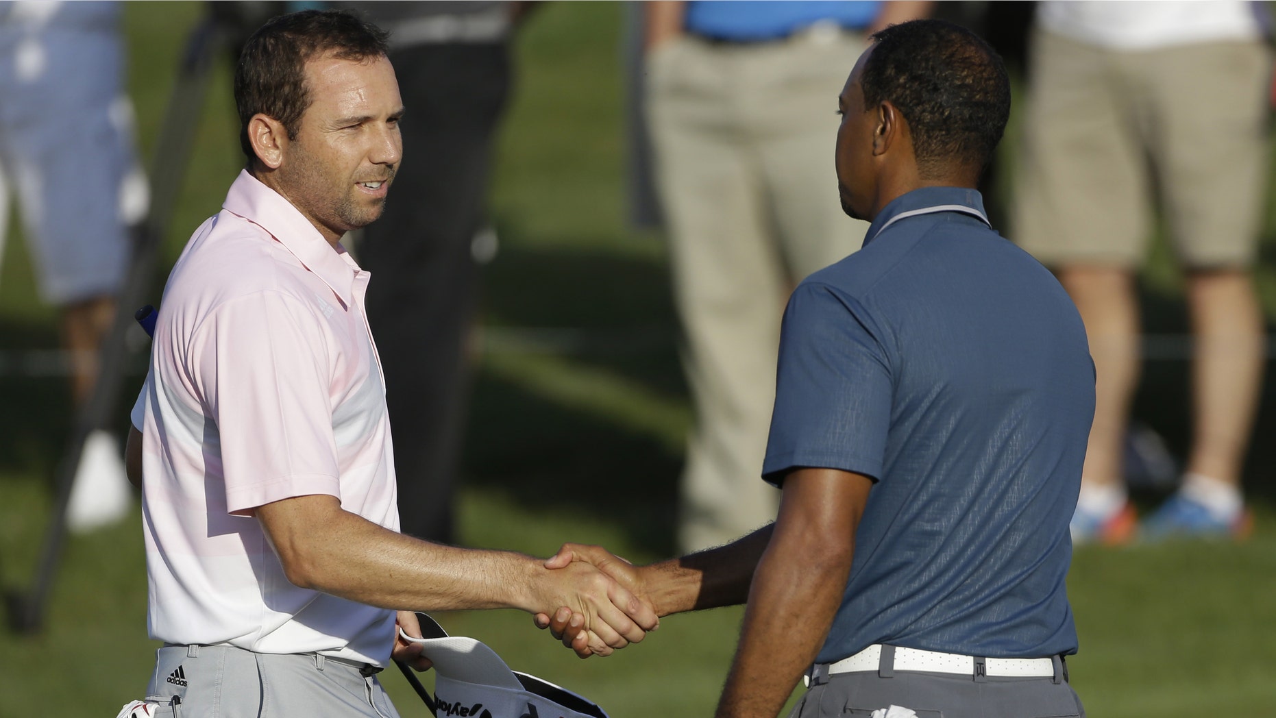 Sergio Garcia shakes hands with Tiger Woods at the conclusion of the third round of The Players championship, Sunday, May 12, 2013, in Ponte Vedra Beach, Fla.