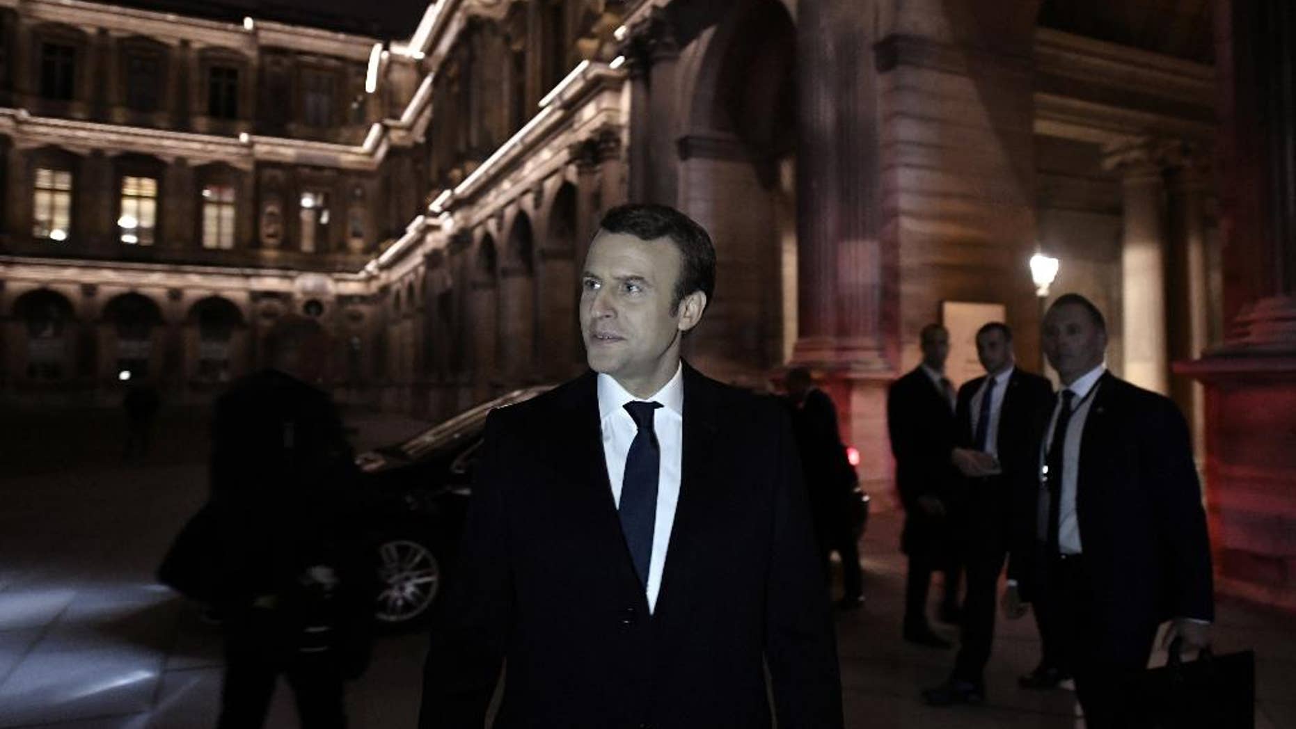 Incoming French President Emmanuel Macron leaves the Louvre Museum after addressing his supporters in Paris, Sunday May 7, 2017. Macron says that France is facing an "immense task" to rebuild European unity, fix the economy and ensure security against extremist threats. (Philippe Lopez/Pool Photo via AP)