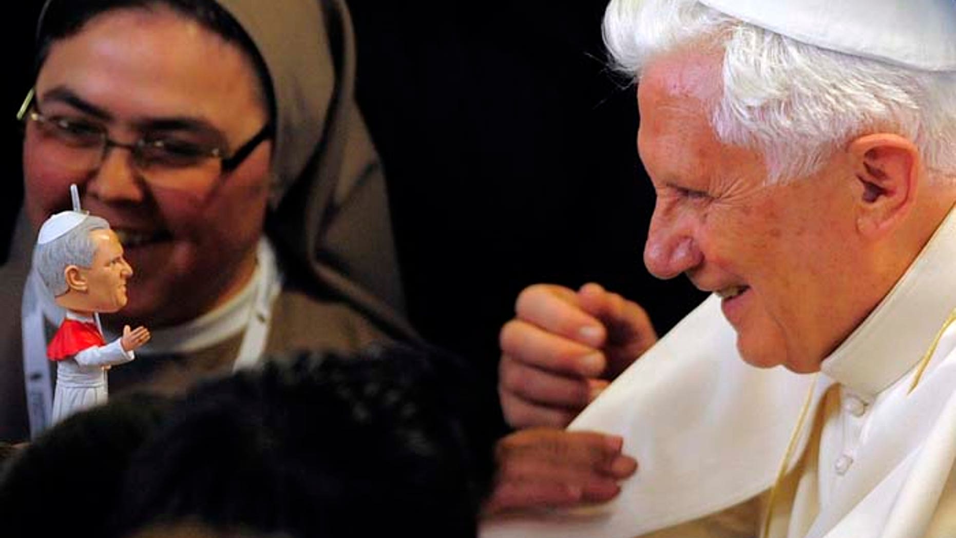 Pope Benedict XVI receives a replica of himself at the Nen Deu institute in Barcelona, Spain, Sunday, Nov. 7, 2010. The Pope consecrated La Sagrada Familia, the Barcelona landmark designed by Antoni Gaudi, whose construction began in 1882 and continues today. (AP Photo/Manu Fernandez)